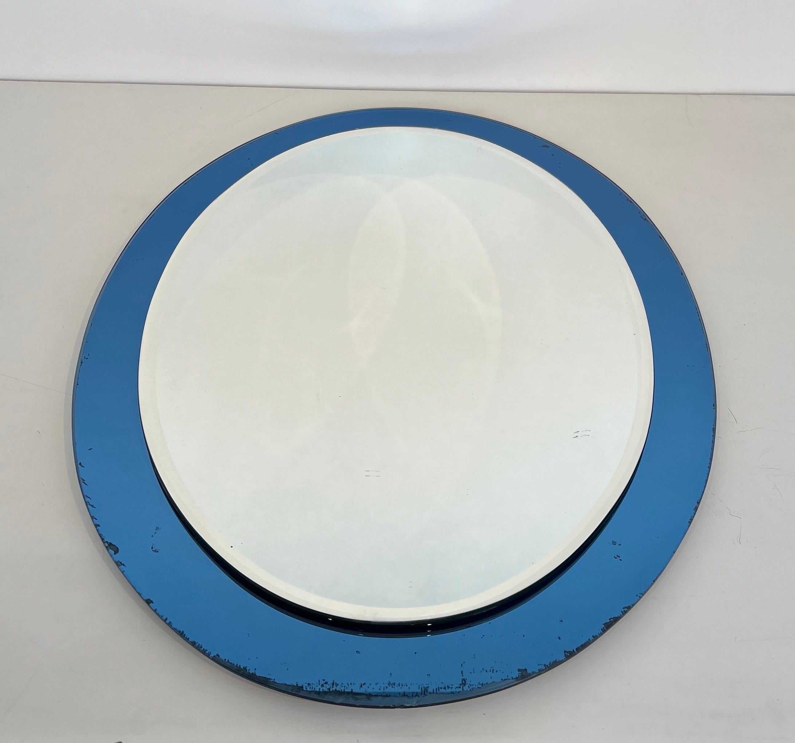 Questo bellissimo specchio di forma ovale è composto da uno specchio ovale con un bordo bluastro (un po' di usura sul bordo dello specchio). Questa è un'opera italiana di Fontana Arte. Circa 1970