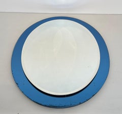 Oval-Shaped Mirror with a Bluish Surround by Crystal Art Torino. Circa 1960