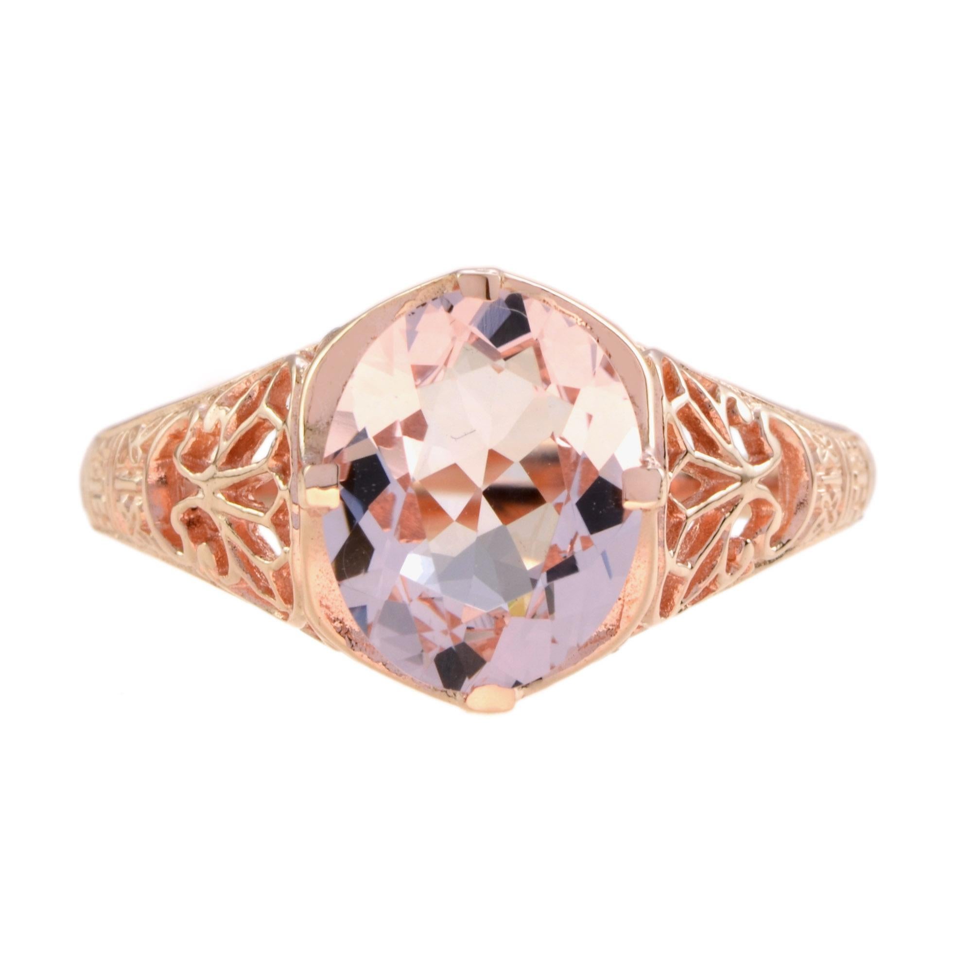 This romantic vintage style filigree morganite engagement ring features a shimmering oval peach pink morganite gemstone of 2.10 carat, nestle in a secure 4 prong setting atop a delicate trellis of 9k rose gold filigree. 

Ring Information
Style: