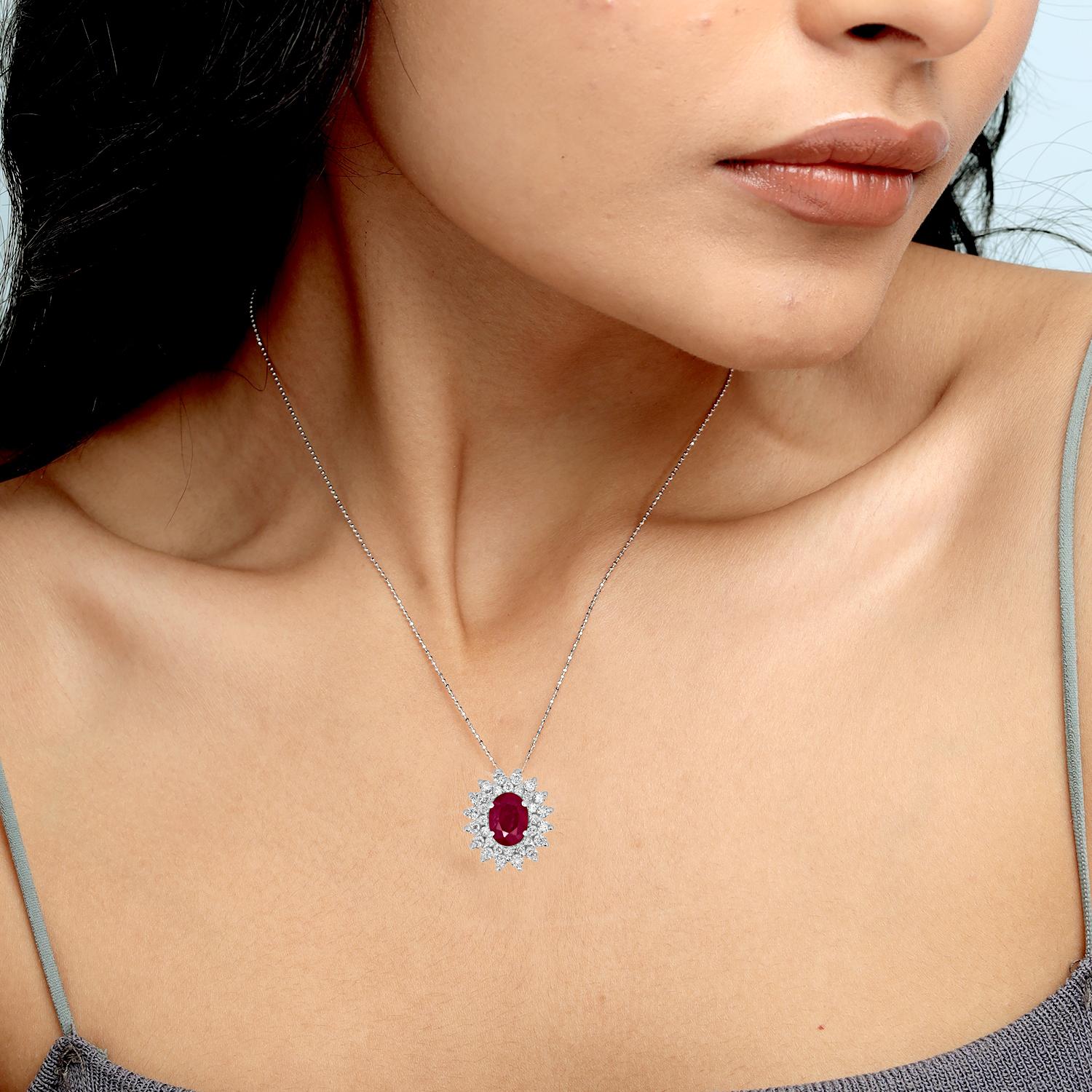 Striking in its simplicity, this elegant pendant features an oval-shaped Mozambique ruby weighing 0.97 carats, brought to life by a halo of sparkling diamonds totaling 0.44 carats. Crafted in 18KT white gold and weighing just 1.05 grams, this piece
