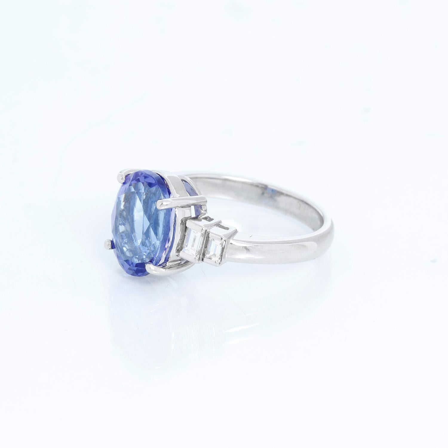 Oval Shaped Tanzanite with Diamonds Platinum Ring Size 7 - Center oval stone set in Platinum with two baguette diamonds on each side. Size 7 but can be sized. Pre-owned with DeMesy box .