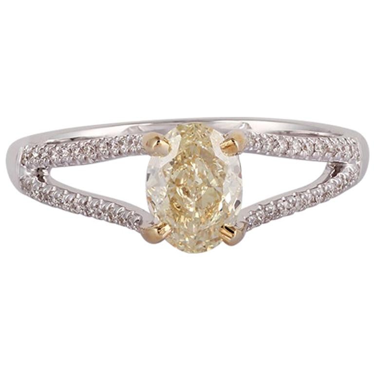 Oval Shaped Yellow Diamond Ring Studded in 18 Karat White Gold For Sale