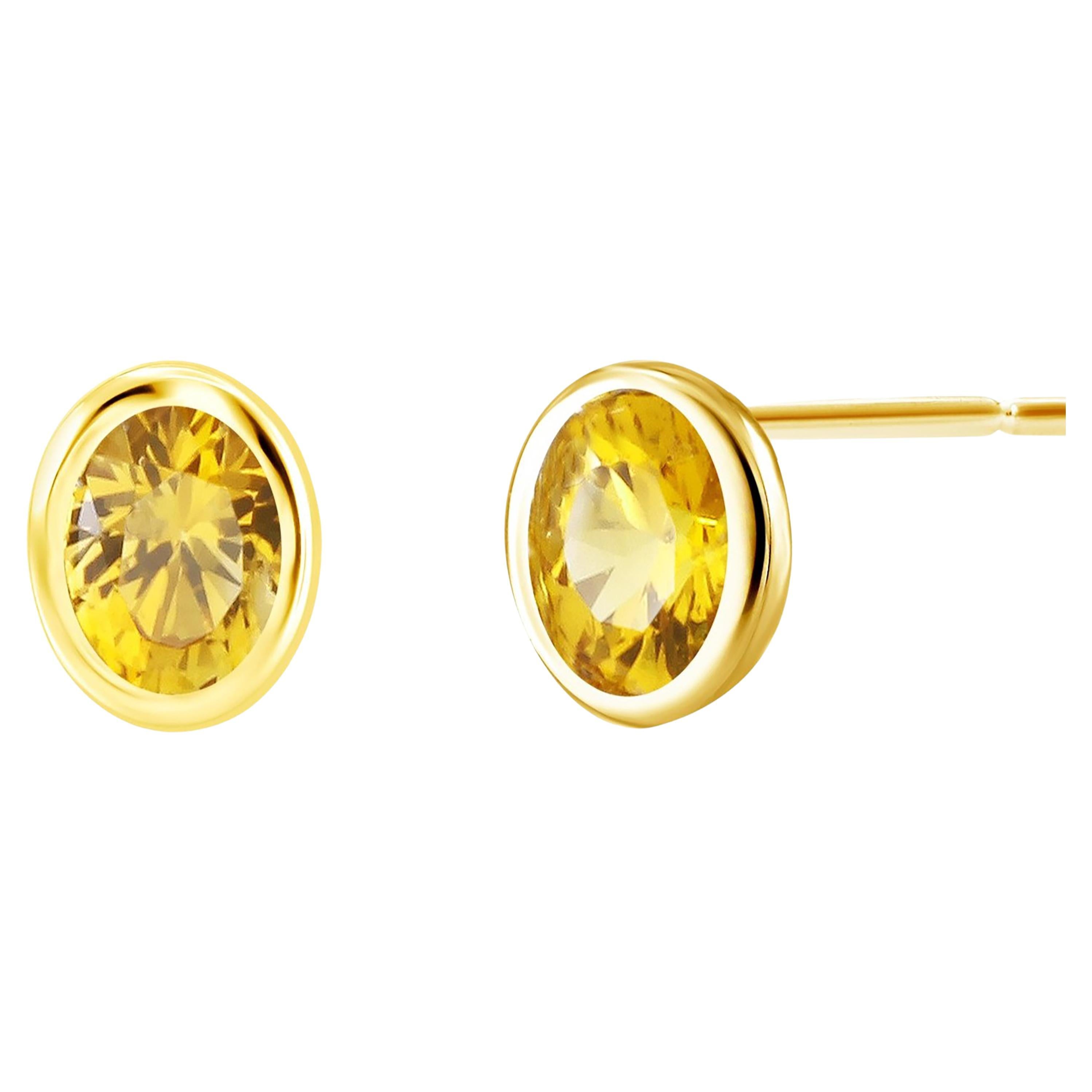 Oval Shaped Yellow Sapphire Bezel Set in Yellow Gold Stud Earrings