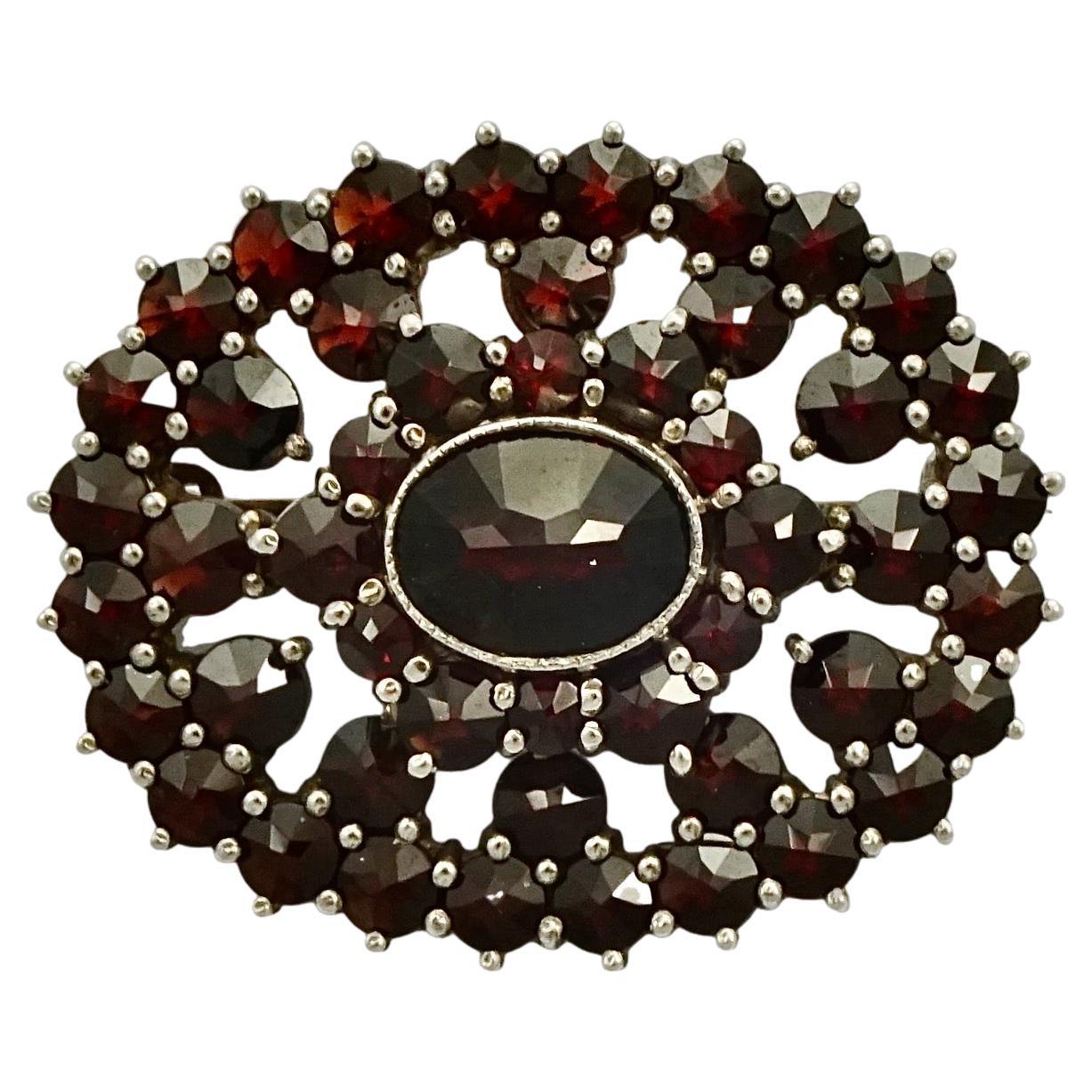 Oval Silver and Garnet Brooch circa 1930s For Sale