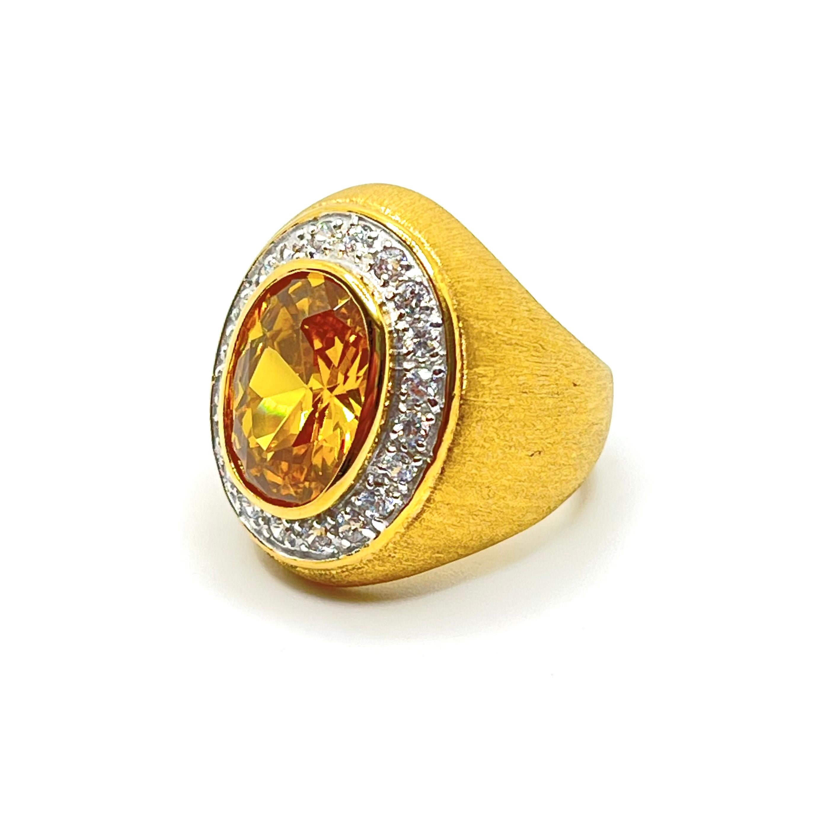Halo Oval Simulated Yellow Topaz and Simulated Diamond Vermeil Dome Ring

This bold cocktail ring features beautiful top quality 6.5ct oval simulated topaz with halo round simulated diamond cubic zirconia, handset in two-tone 18k yellow gold vermeil