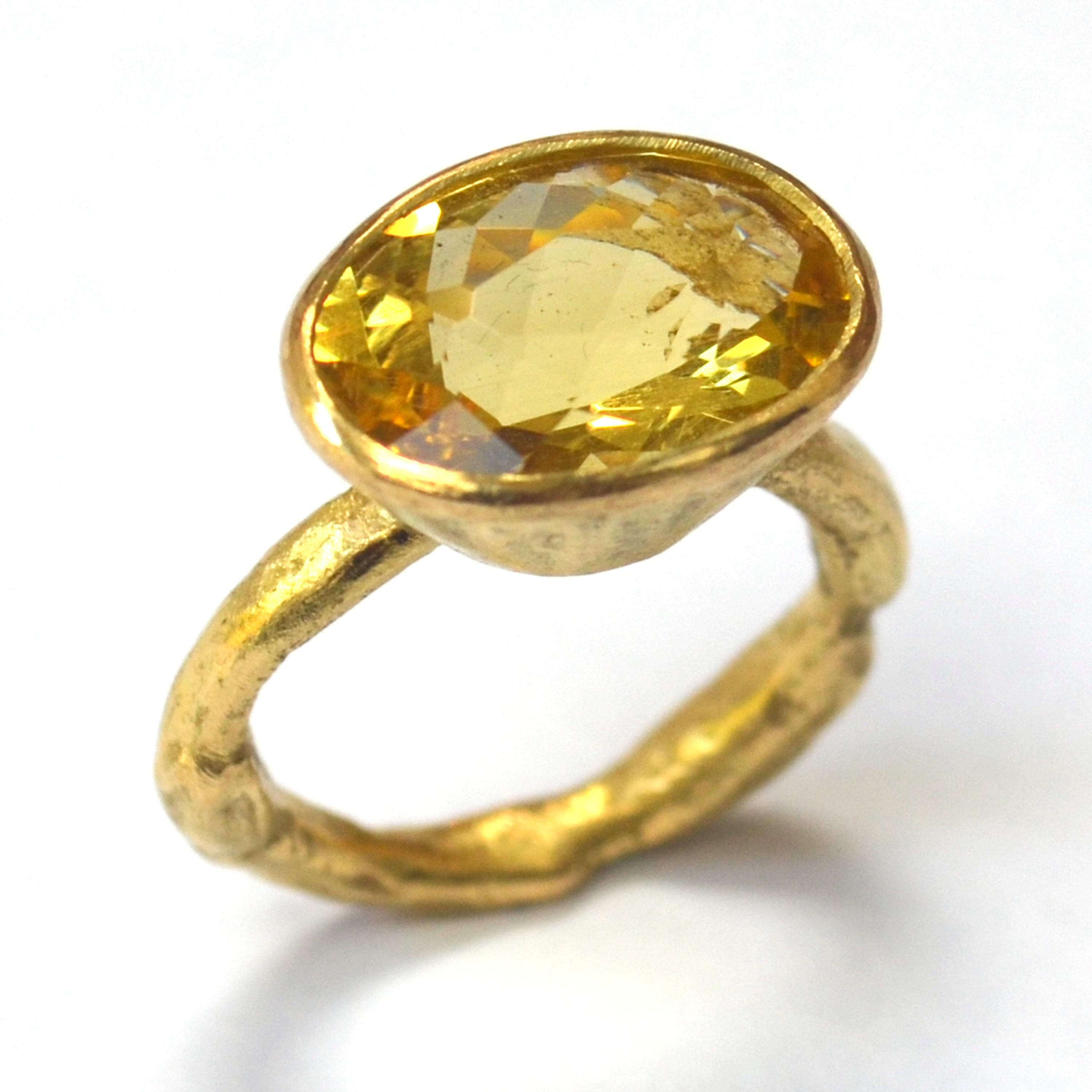 Large oval 6 carat Yellow Zircon set in a tapered 18k yellow gold setting on organic textured 18k yellow gold ring. This ring is a ray of sunshine on your hand! The canary yellow of the Zircon pops in any light and is complimented by the warm tones