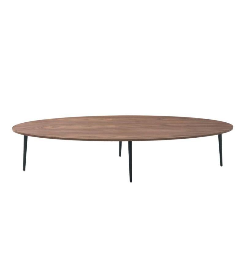 Oval Soho coffee table by Coedition Studio
Materials: top in walnut veneer on MDF. Black lacquered metal conical legs.
Dimensions: W 160 x D 55 x H 33 cm
Available in different sizes and shapes, and in sets. 

The Soho oval coffee table is a sleek