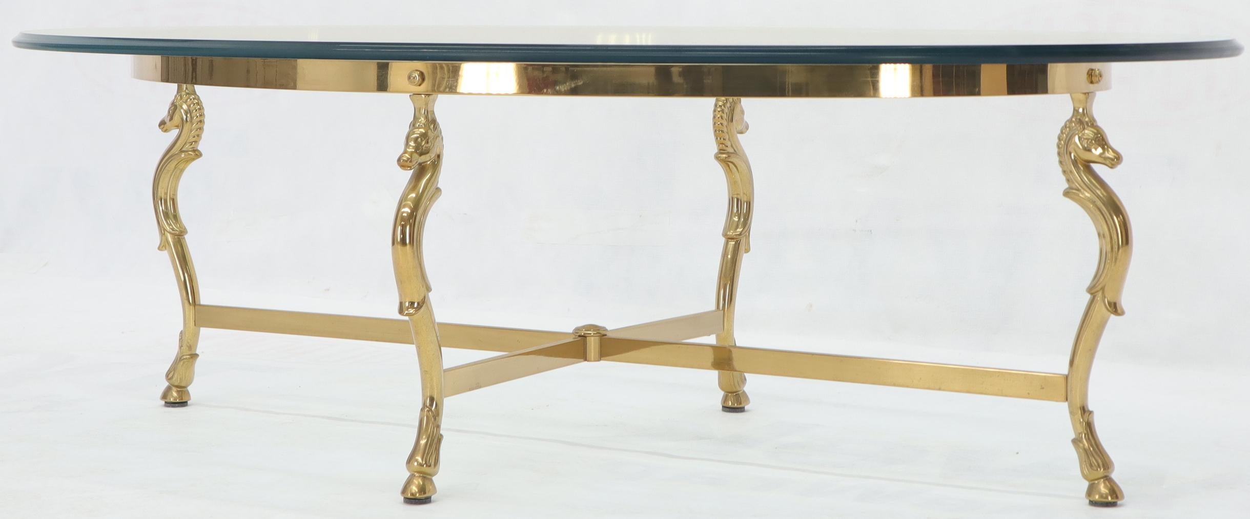 Midcentury Italian modern oval thick glass top brass base coffee table.