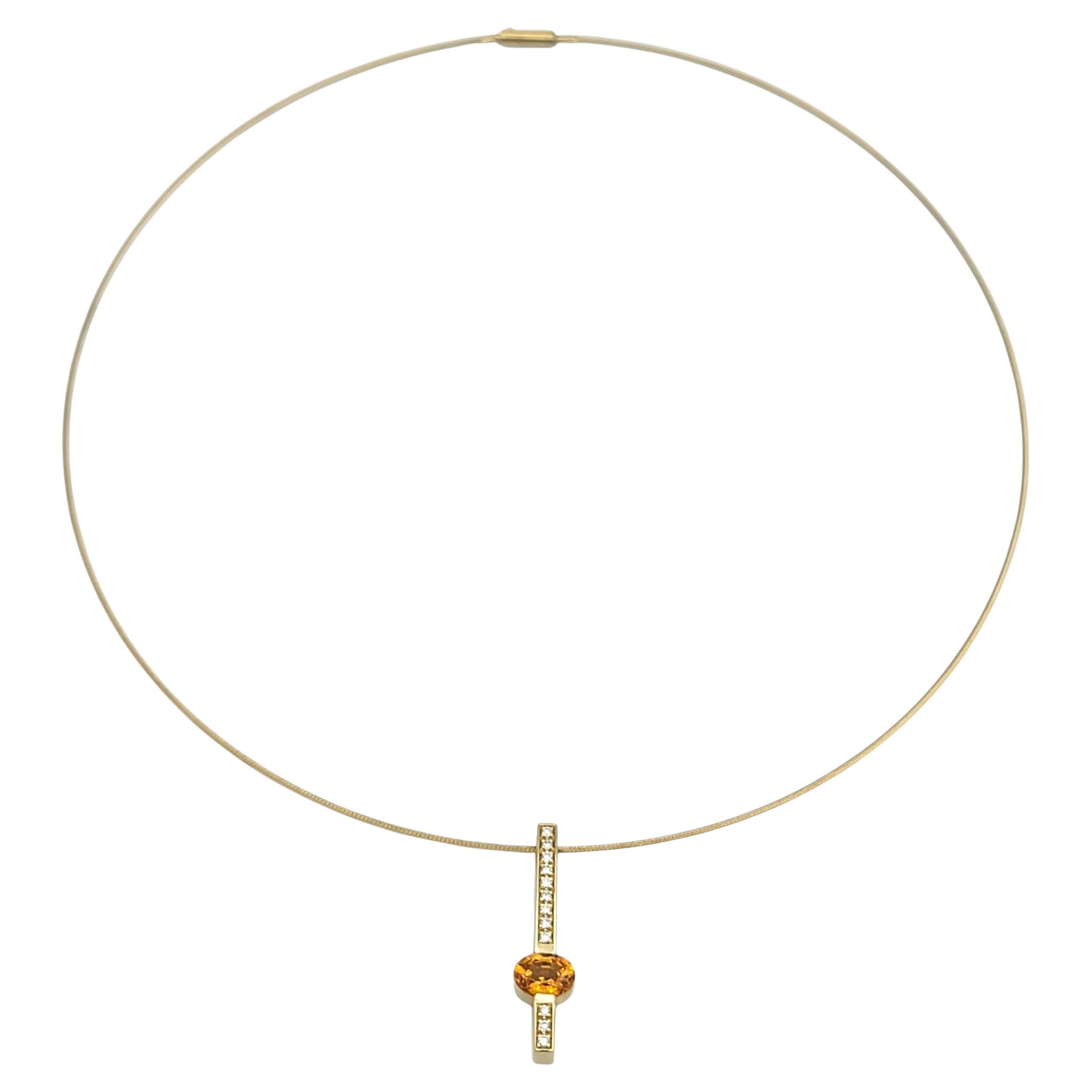 Questa straordinaria collana è caratterizzata da un ciondolo a barra verticale di diamanti in oro giallo 14 carati, accentuato al centro da un granato spessartite di forma ovale. La calda tonalità arancio-dorata del granato crea un bellissimo
