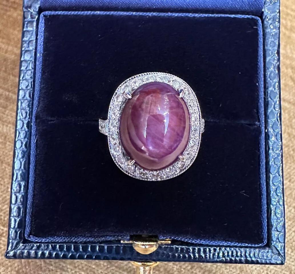 Oval Star Ruby 17.83 carat and Diamond Halo Ring in 18k White Gold 

Oval Star Ruby and Diamond Halo Ring features a 17.83 carat Natural Cabochon Star Ruby with Oval-shape with a Halo of Round Brilliant Diamonds around the Ruby and along the shank,