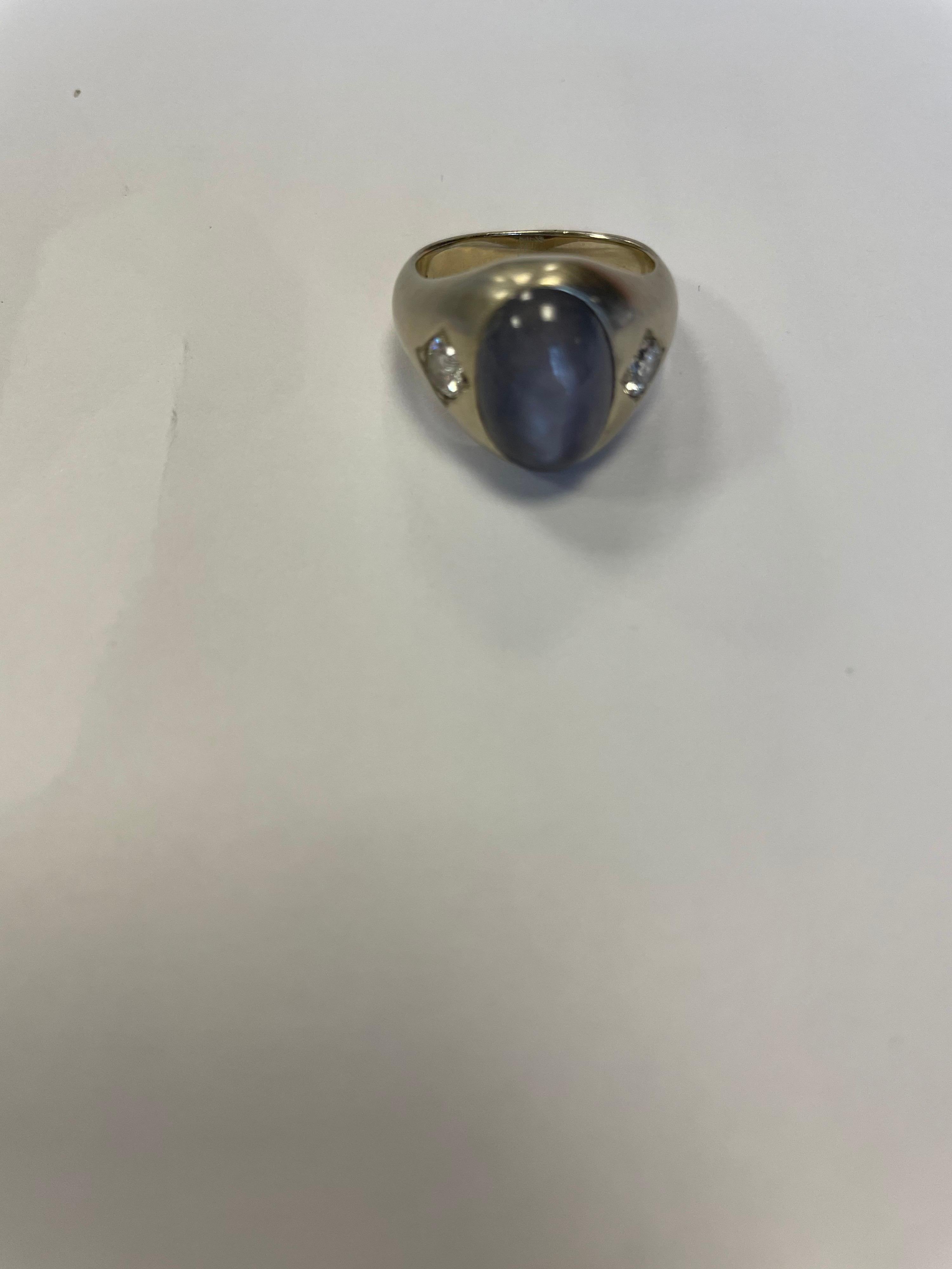 14K white gold ring with oval shape Star Sapphire weighing approximately 8cts and two round faceted diamonds weighing .60cts total. 
Finger size 5.75, may be sized
Last retail $4500