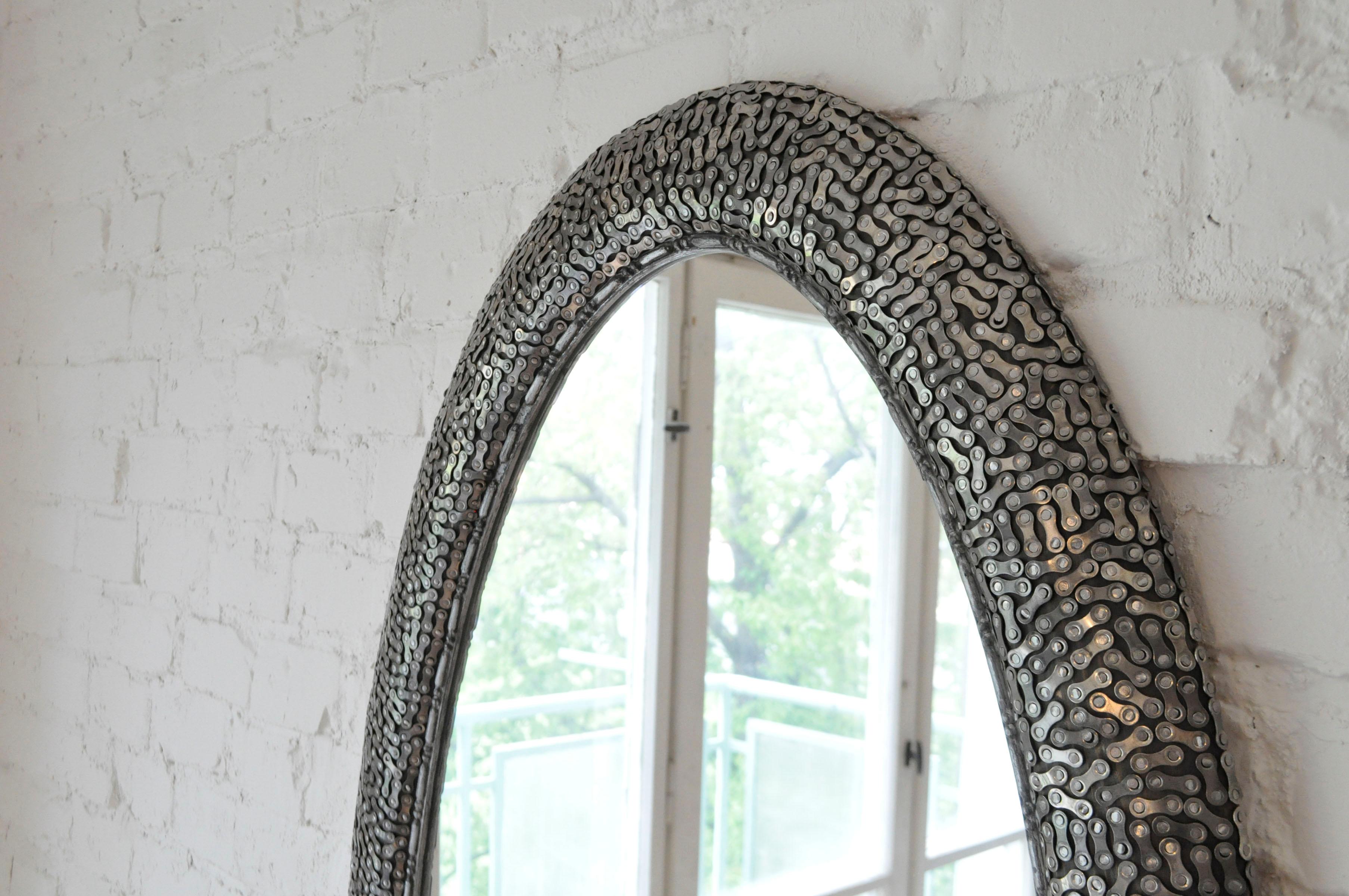 Oval decorative steel mosaic wall mirror, nailed bike chain links technique, luxury upcycled. Wooden mirror is made from old oval picture frame decorated by signature decorative technique using bike chain elements individually and densely nailed