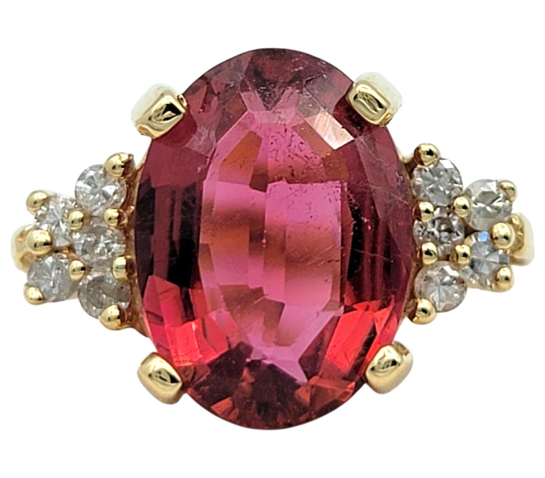 Ring Size: 6.25

This stunning ring showcases a vivid 2.35 carat oval step cut pink tourmaline that instantly draws the eye with its rich saturation and lively brilliance. The centerpiece is securely nestled in a classic four-prong setting and