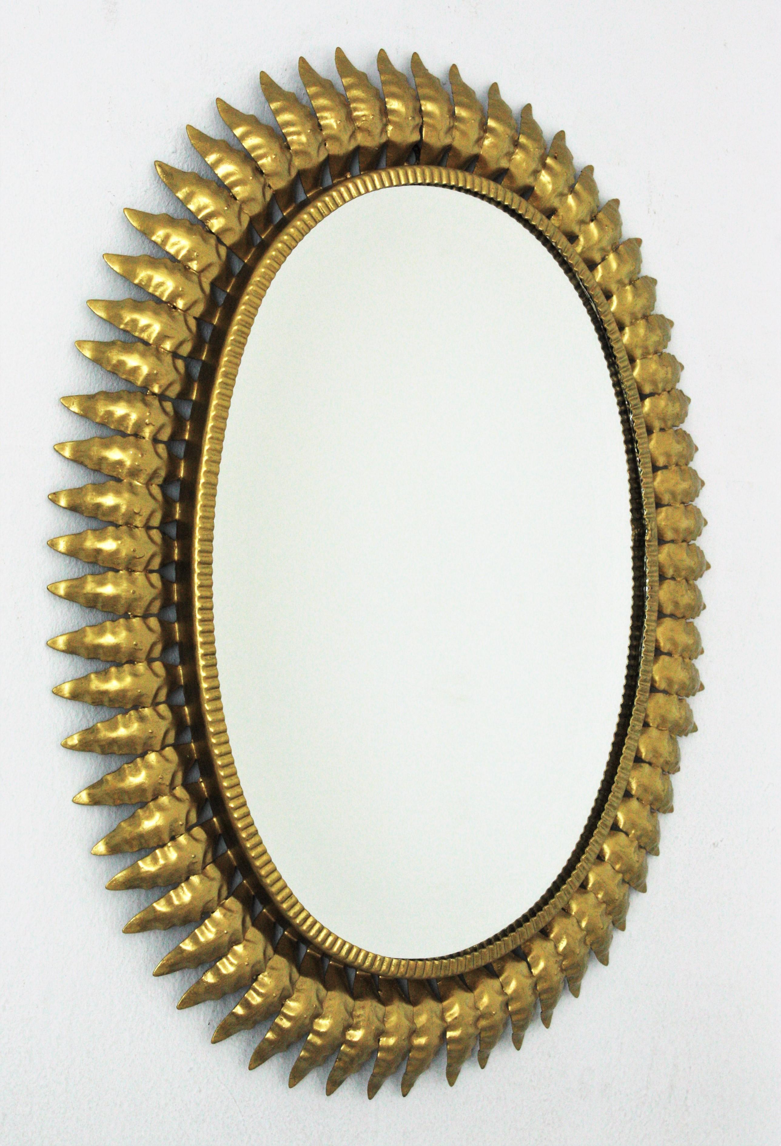 Hammered 1960s Spanish Sunburst Oval Mirror, Gilt Iron For Sale