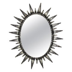 Espejo Oval Sunburst de Hierro Patinado Plateado