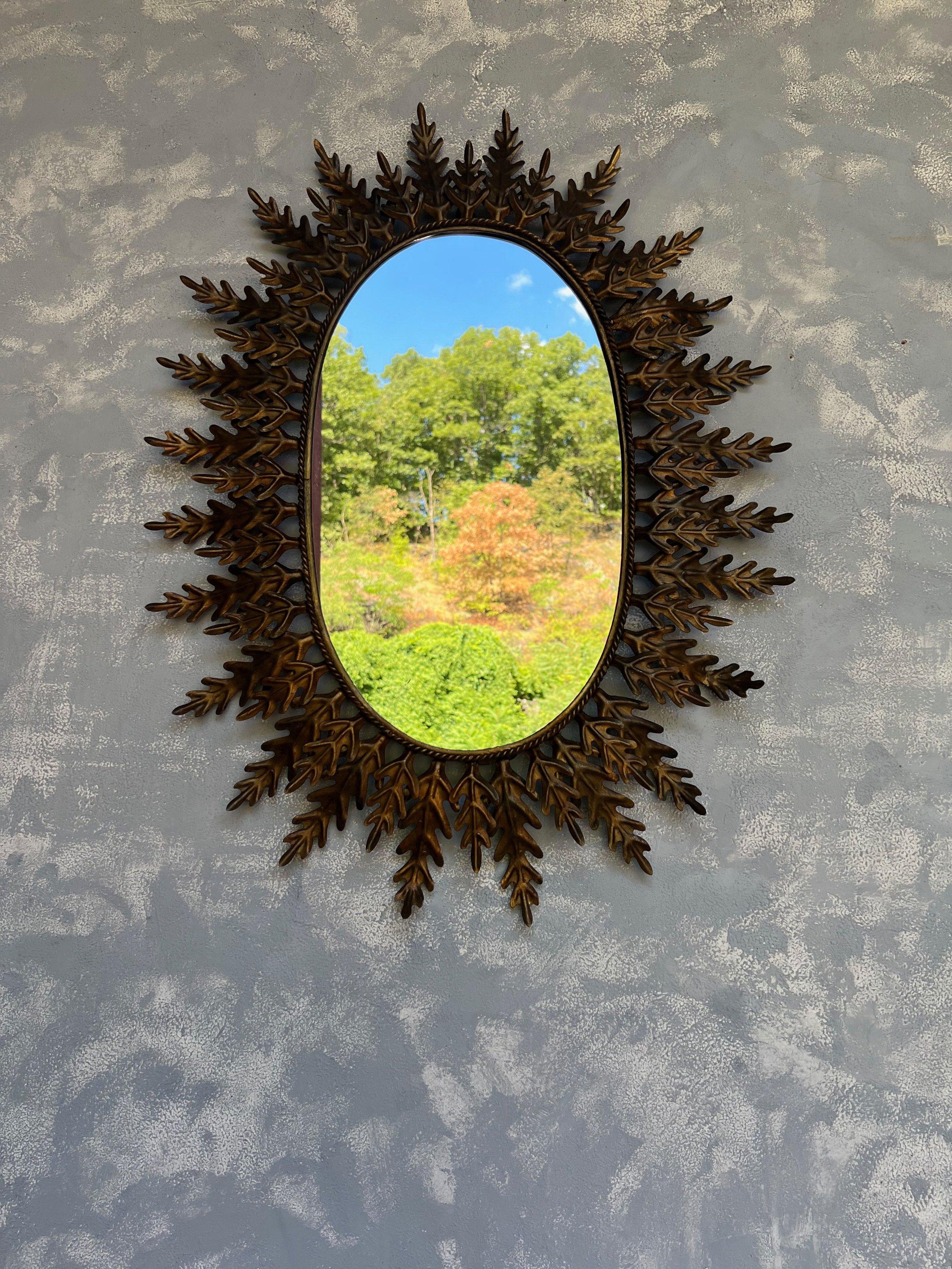 Gilt Oval Sunburst Mirror with Alternating Leaves For Sale