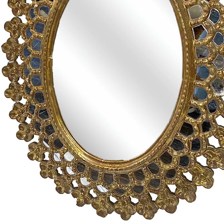 A circa 1920s Spanish gilt sunburst mirror with mirrored details on scalloped frame.

Measurements:
Height 36