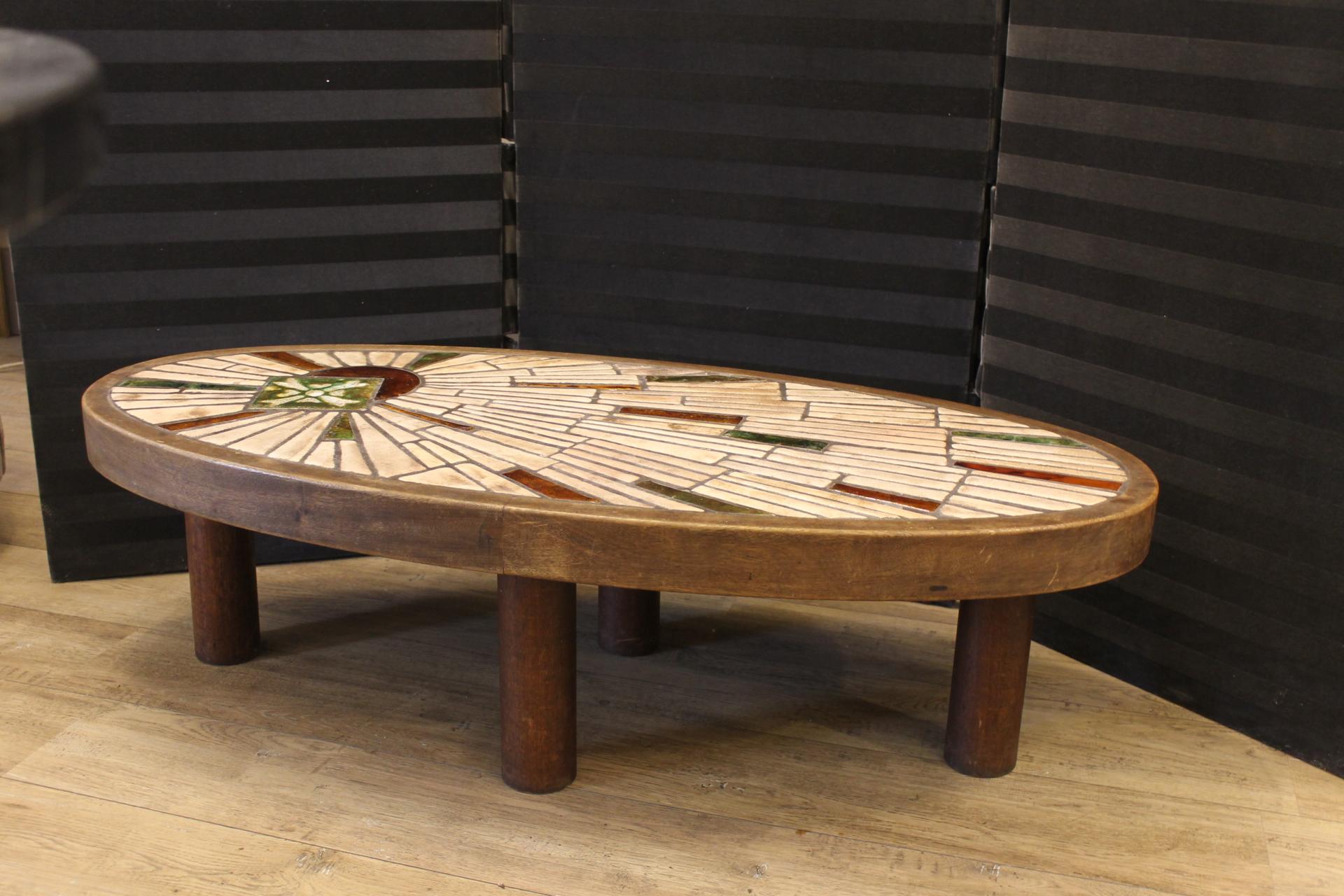 Oval coffee table in beige, red and green colored ceramic tiles, made in the 1950s. Structure in dark wood.
In the style of Caperon, Vallauris.
Of good quality in good condition.
No broken tiles.
