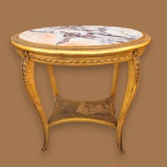 Oval table in gilded and carved wood, 19th century