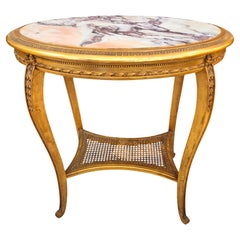 Mesa ovalada de madera dorada y tallada, S. XIX