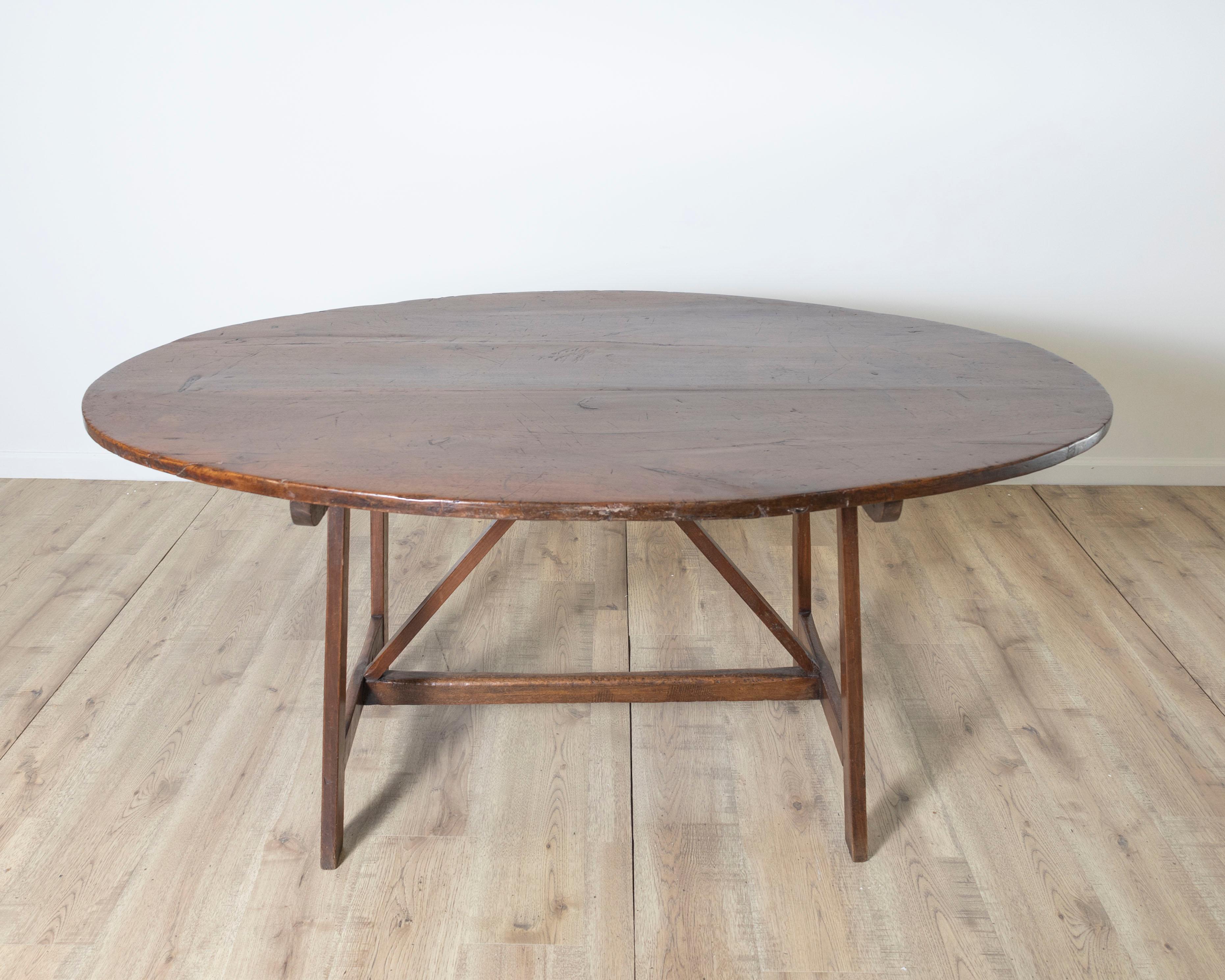 This unique 18th-century Italian table is a rare find, notable for its sculptural goat-leg supports and warm, hand-carved walnut construction. The oval top, modestly sized yet substantial, sits atop an unusual base where the zoomorphic legs,