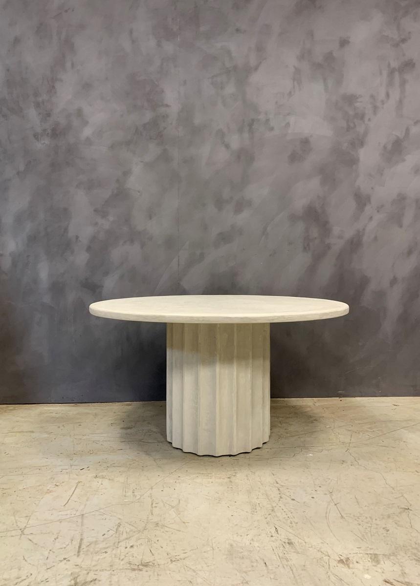 Our SOFIA table was inspired by Classic design and proportions. We purified the idea of a ionic colomn and designed a table around it. The used material is a marbleplaster which petrifies and becomes water resistible with the same qualities as