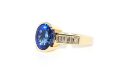 Oval Tanzanite and Diamond Baguette Ring in 14 Karat Yellow Gold
