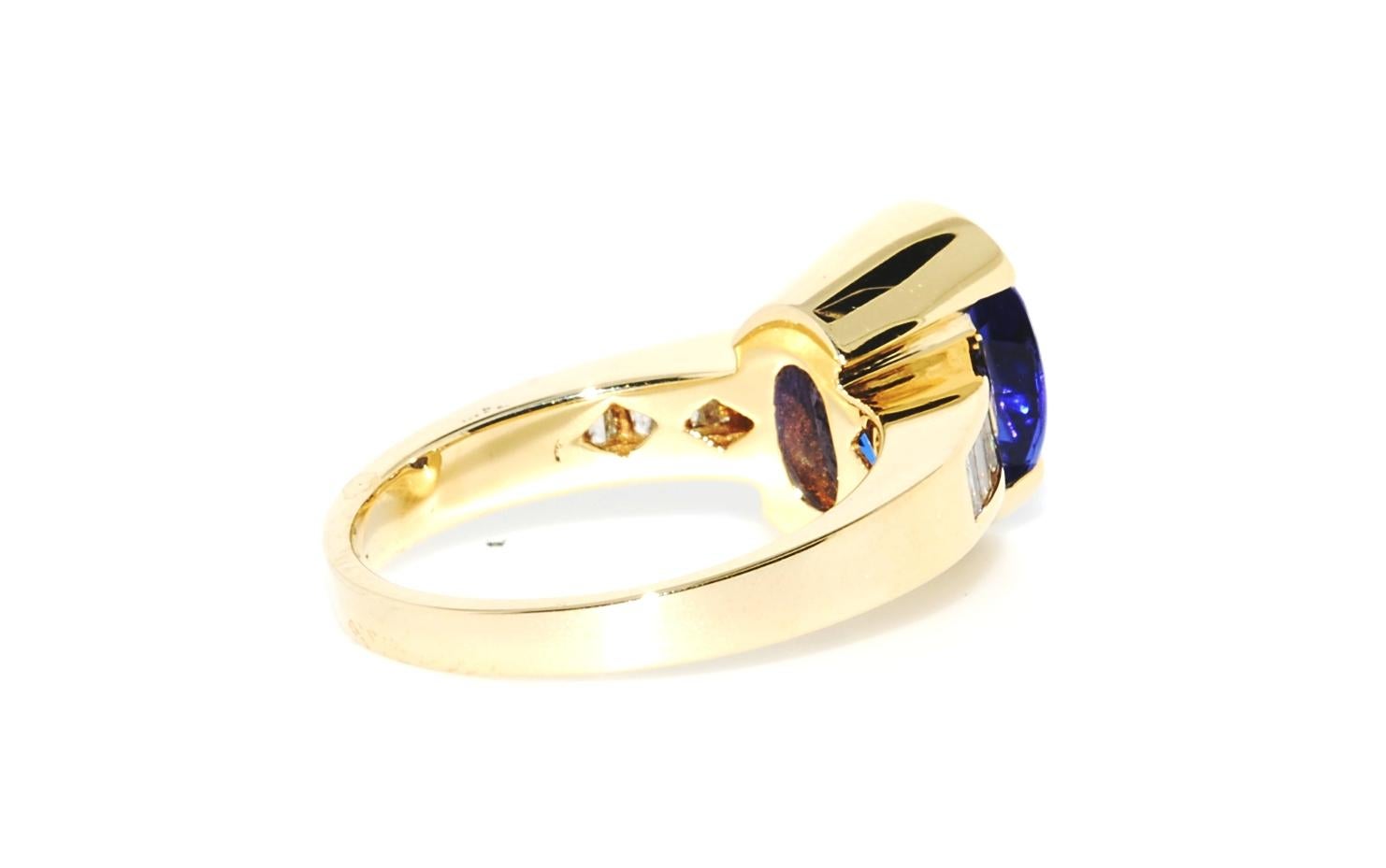 Women's Oval Tanzanite and Diamond Baguette Ring in 14 Karat Yellow Gold For Sale