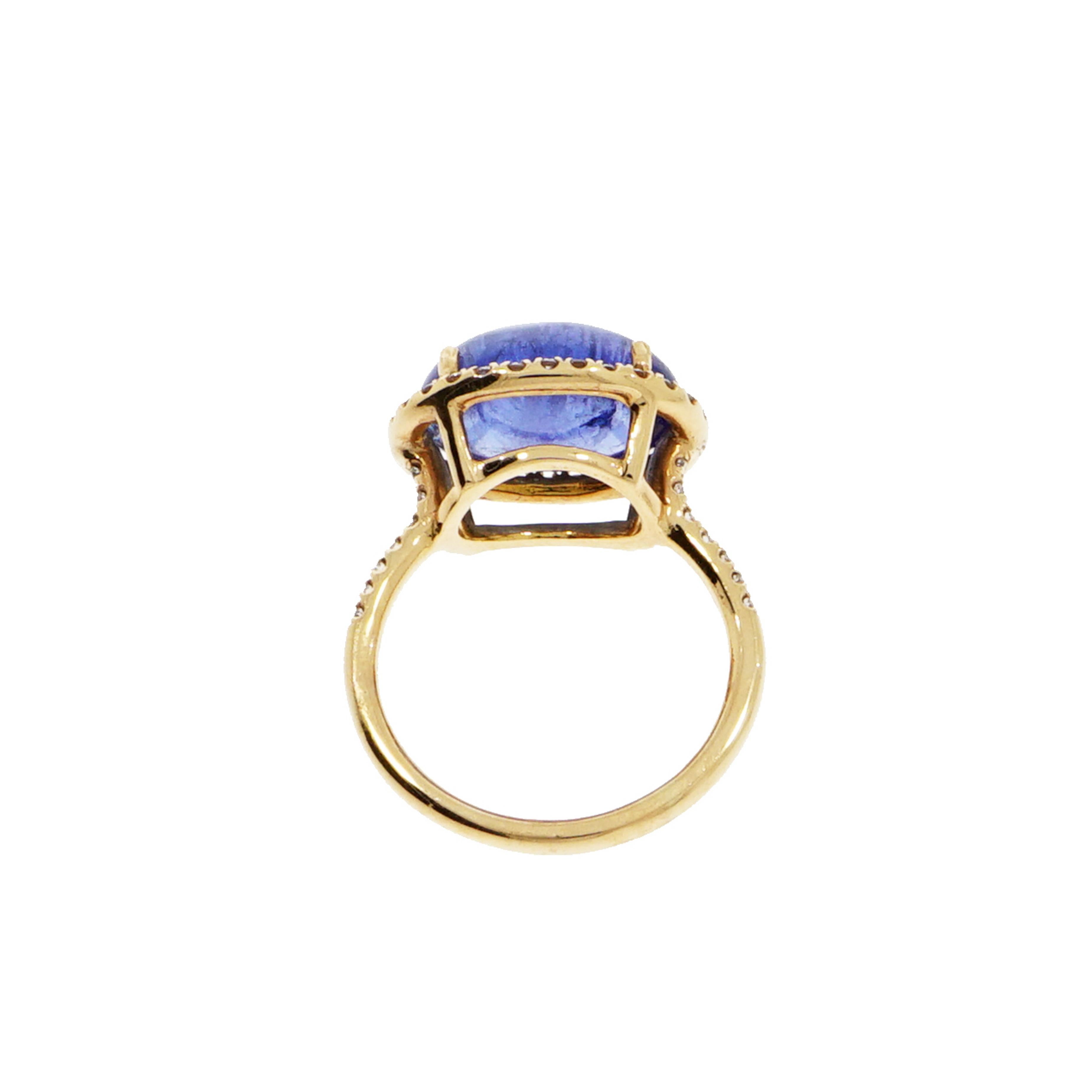 A precious gift from Nature... Oval shaped Tanzanite Cabochon cut, meticulously crafted and designed in NYC, using 18k rose gold to create this beautiful Tanzanite Ring with a halo of white diamonds.
The Tanzanite weighs approximately 6.94 carat and