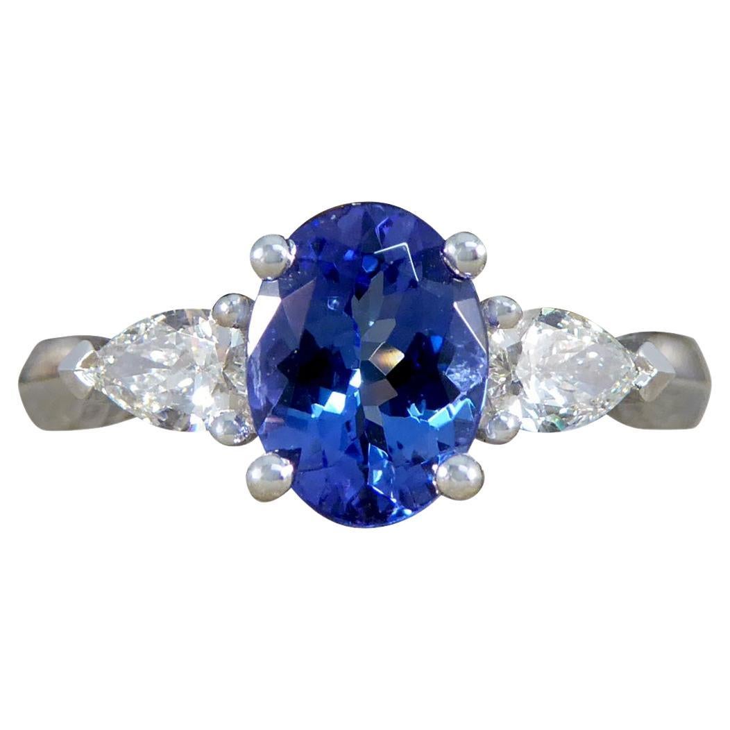 Oval Tanzanite and Pear Cut Diamond Three Stone Ring in Platinum For Sale