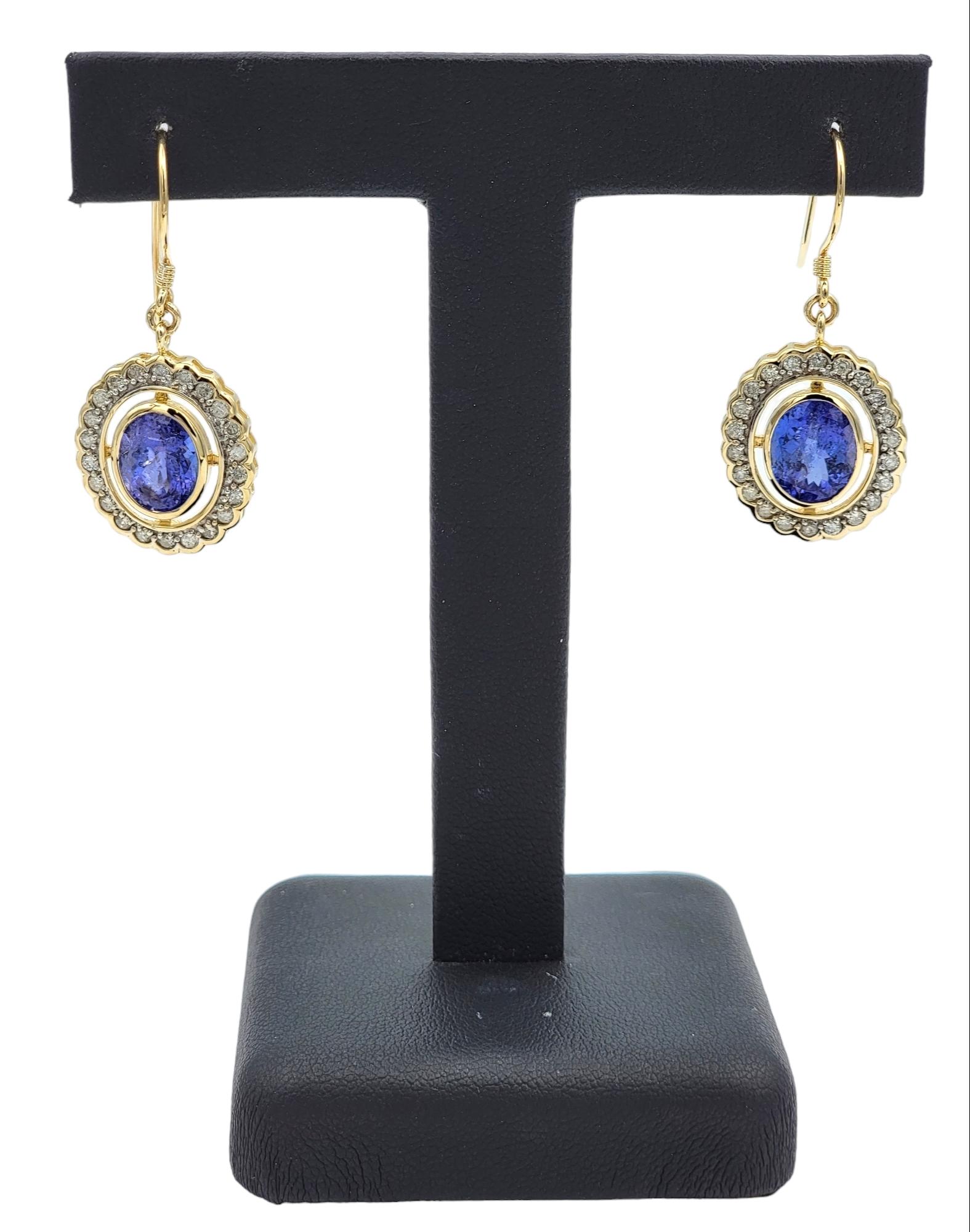 Women's Oval Tanzanite and Round Diamond Halo Dangle Earrings in 14 Karat Yellow Gold For Sale