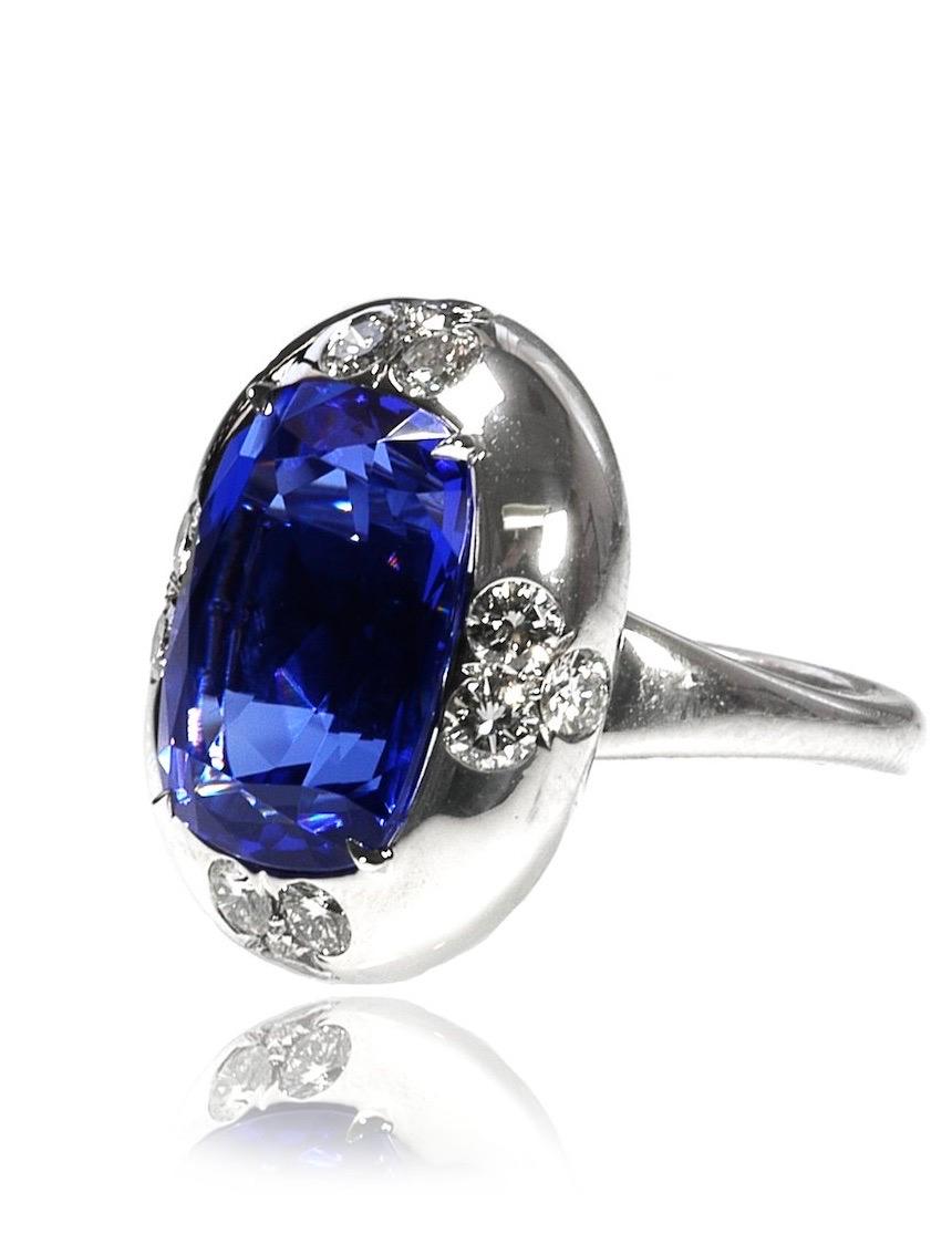 A martini, a Manhattan or a Moscow mule- whichever your favorite cocktail- deserves a matching cocktail ring and this is the one!  The deep, velvety blue, oval tanzanite is set in a bold, platinum, bombé mounting with three round diamonds on each of