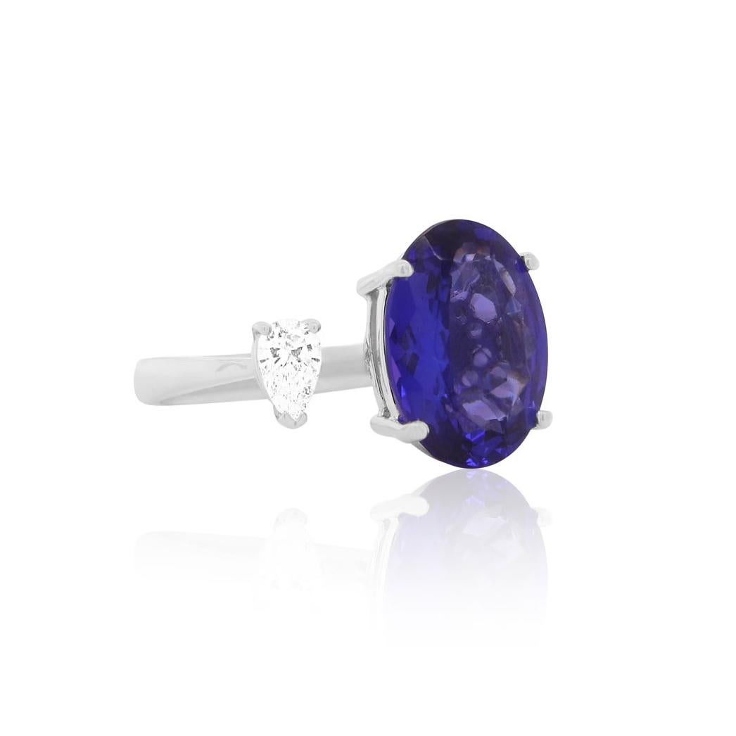Material: 18K White Gold
Center Stone Details: 1 Oval Tanzanite at 6.20 Carats - Measuring 14.2 x 10.6
Side Stone Details: 1 Pear Shape White Diamond at 0.30 Carats Total Weight

Fine one-of-a-kind craftsmanship meets incredible quality in this