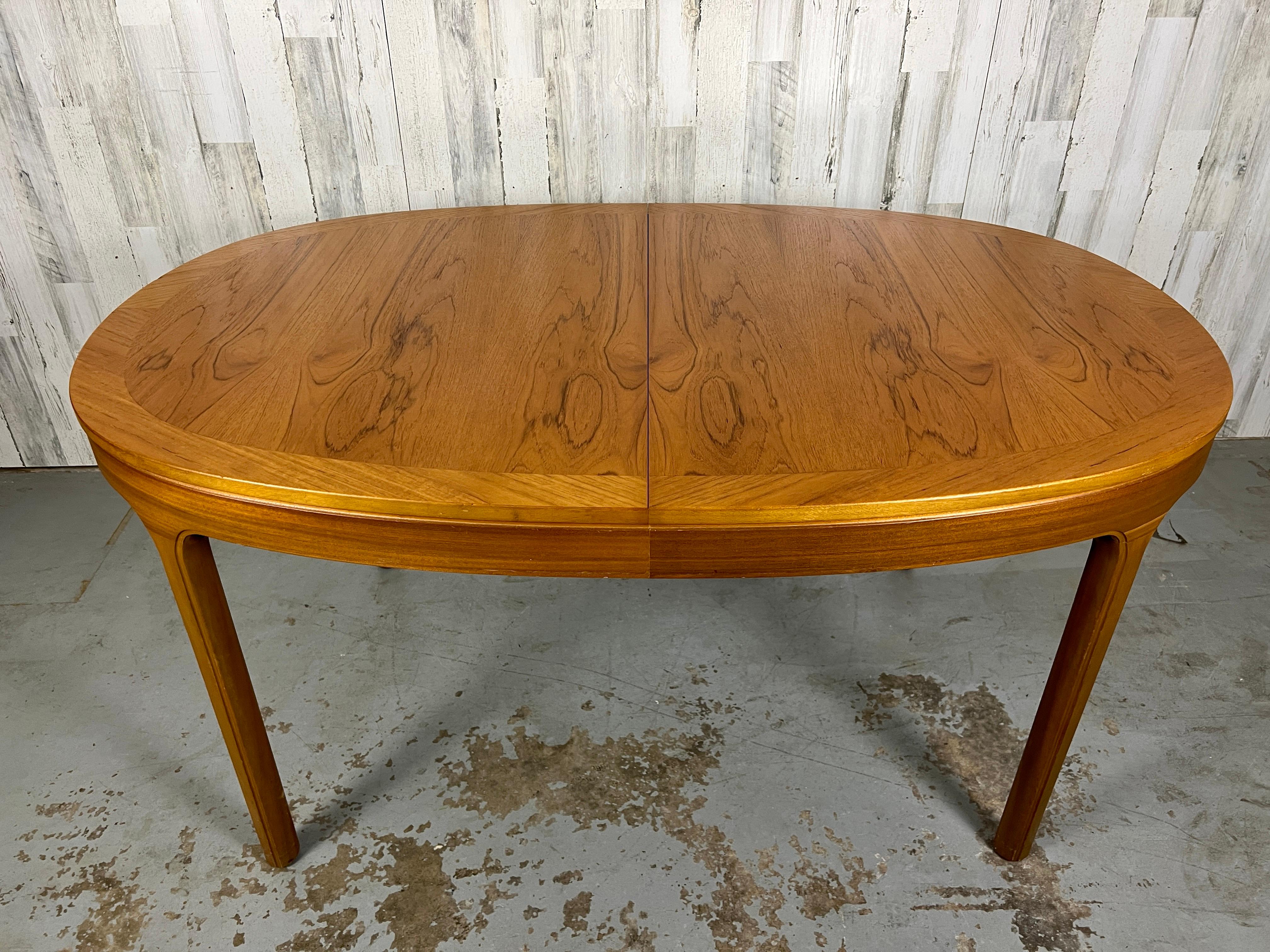 Oval teak dining table by Nathan Furniture with an extendable butterfly leaf. 

81 wide 39 deep 29 3/4 high- leaf in
21 wide leaf
No leaf 60 wide.