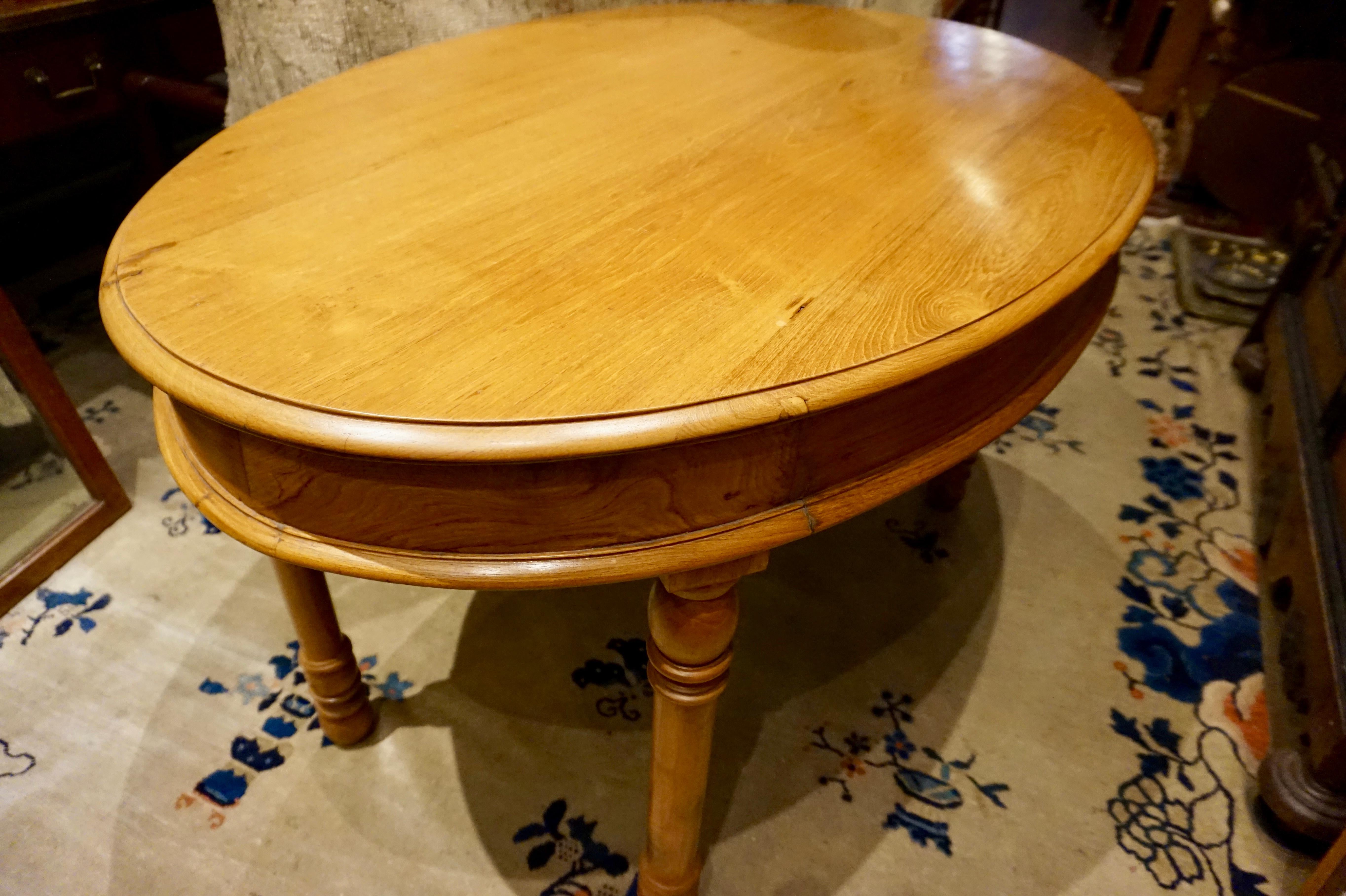 Colonial teak oval dining table/desk. Circa 1890's.
Solid teak Colonial table uncompromisingly constructed from old growth wood with long flowing grains and unique shape yet simple, timeless design. Well preserved and versatile. Exudes warmth. 
