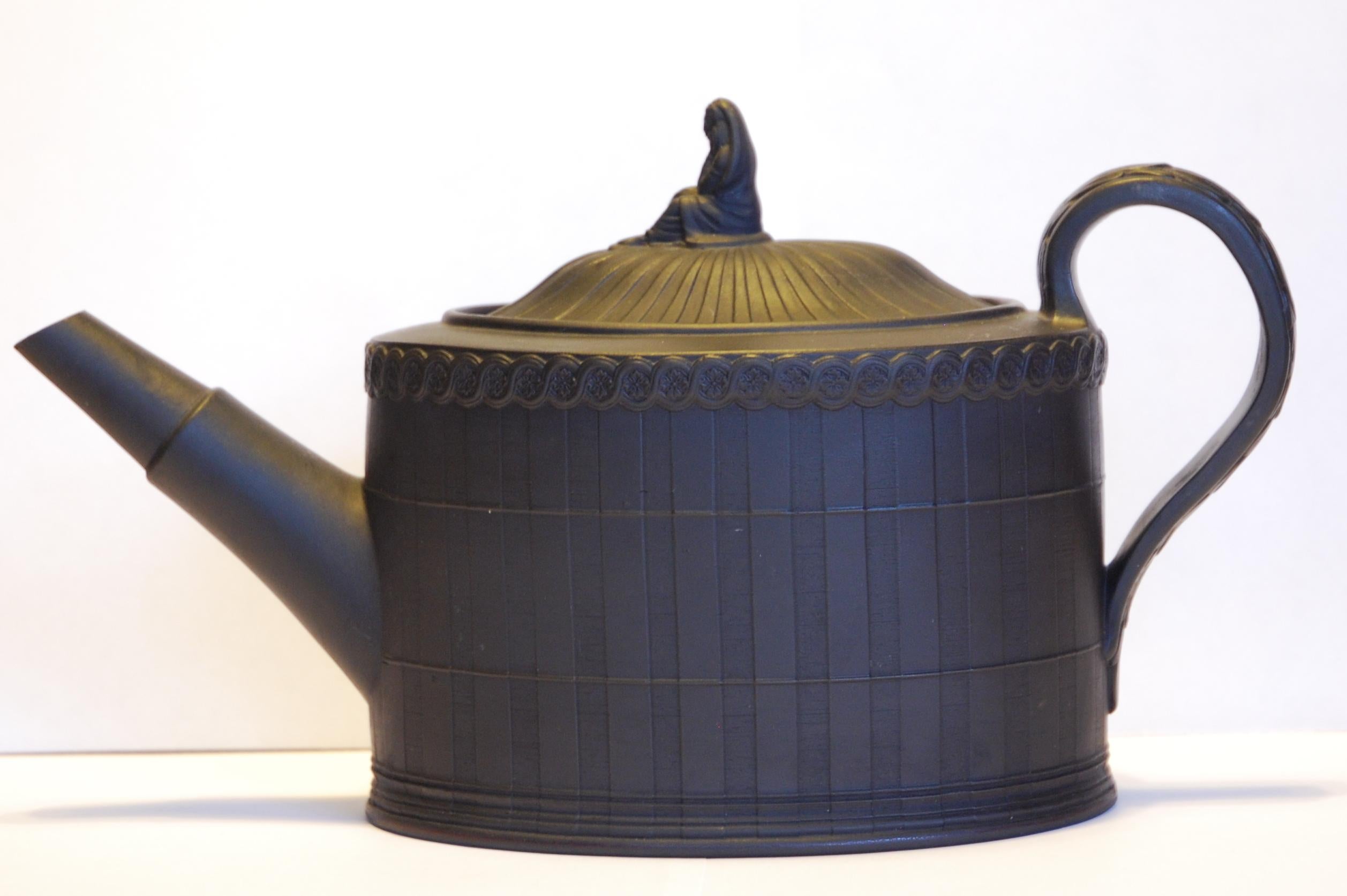 An excellent black basalt teapot, with engine turned decoration and widow finial. Most unusually, this example is marked.