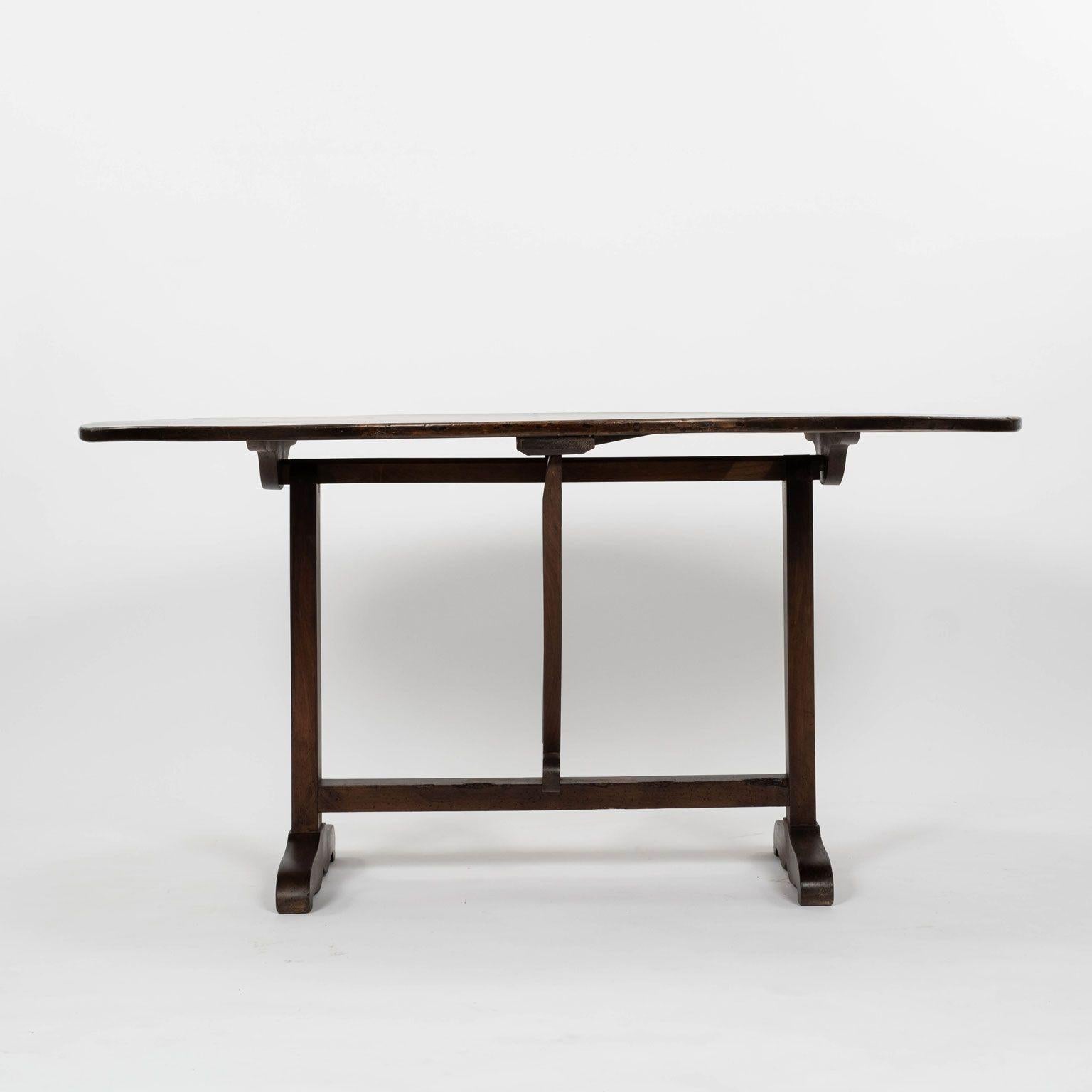 Oval tilt-top walnut table from France. Hand-carved circa 1870-1899 with mortise and tenon joints. Sturdy, stable.