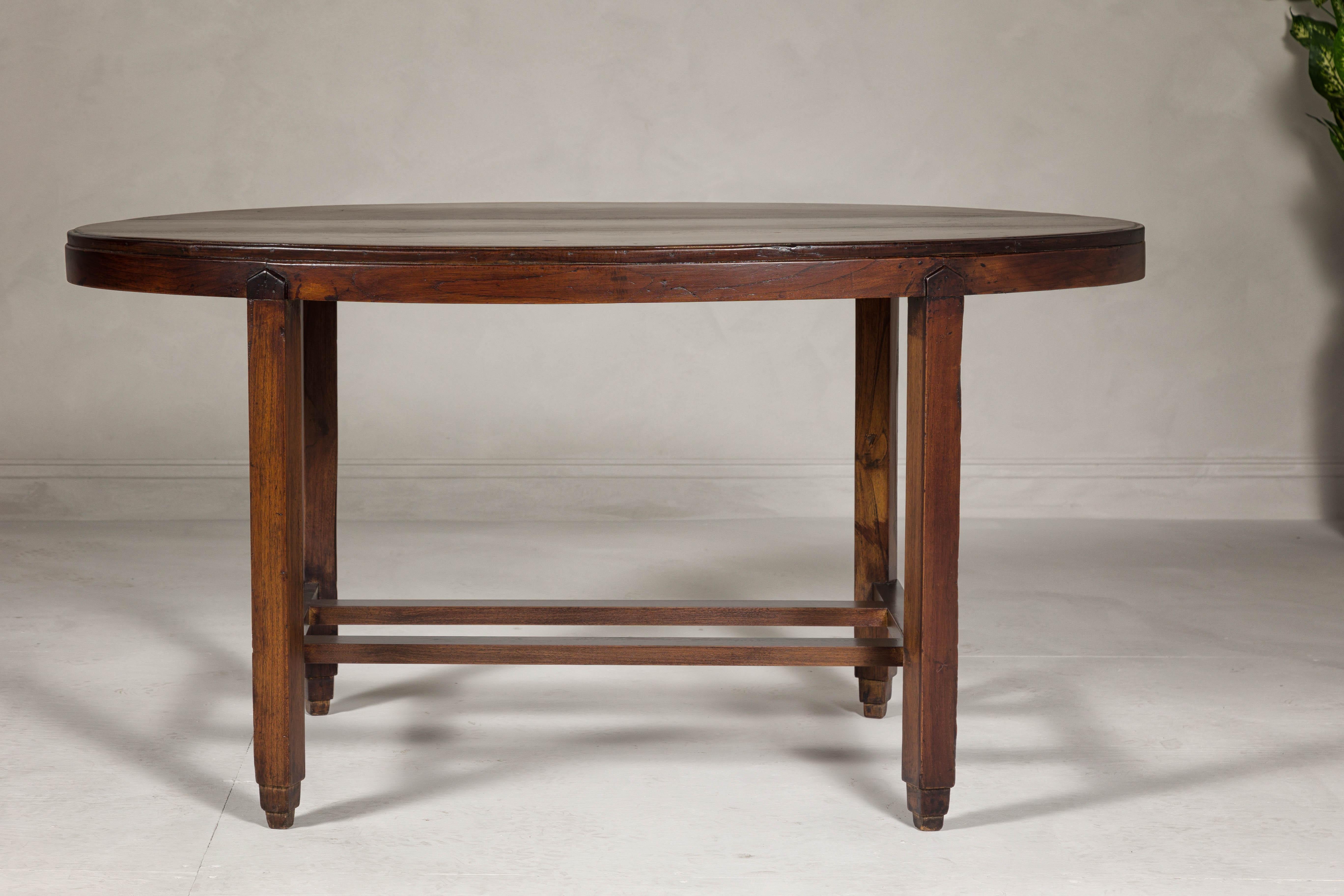 Carved Oval Top Center Table with Inverted Stepped Pyramid Feet and Cross Stretcher For Sale