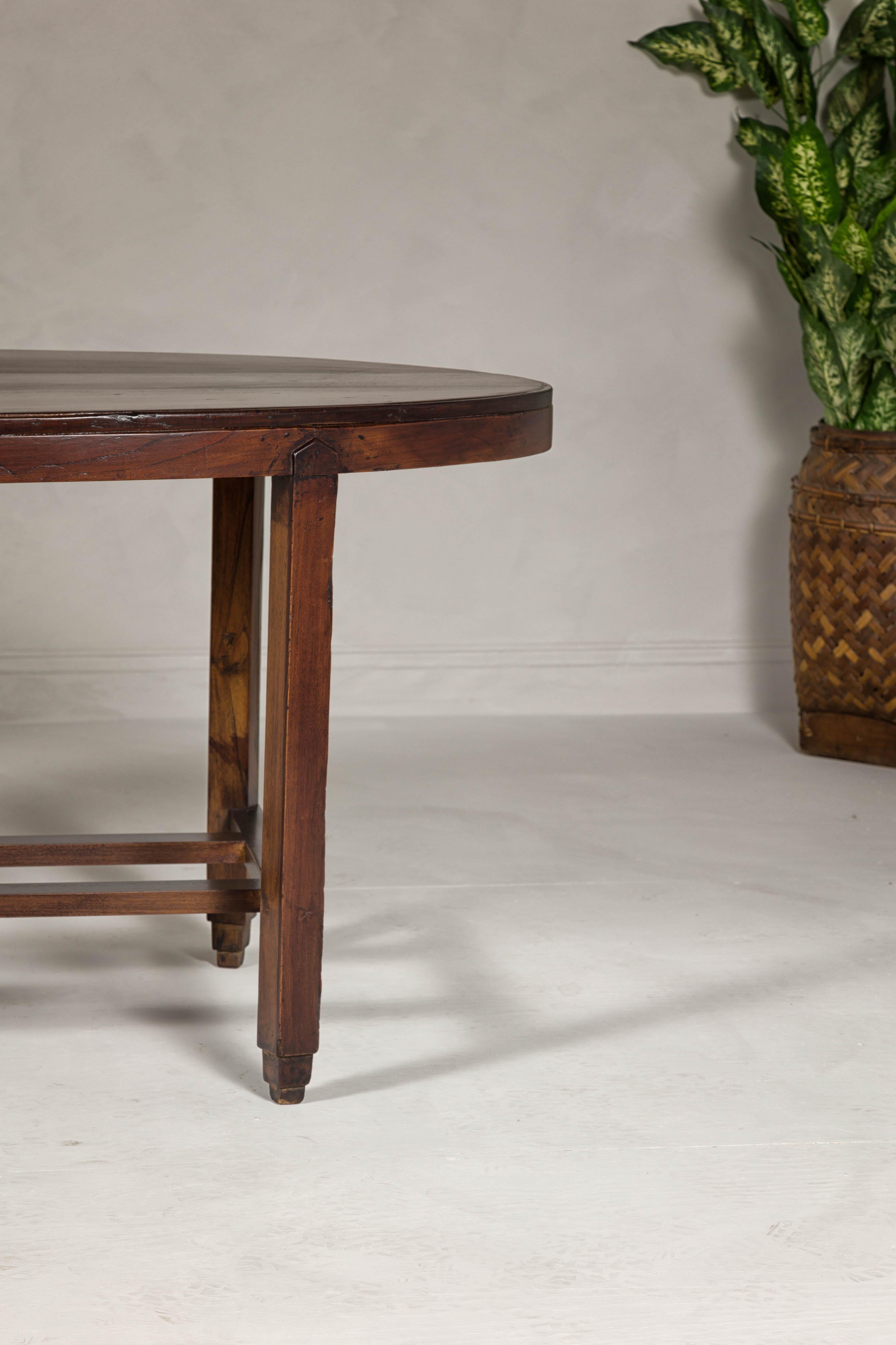 20th Century Oval Top Center Table with Inverted Stepped Pyramid Feet and Cross Stretcher For Sale