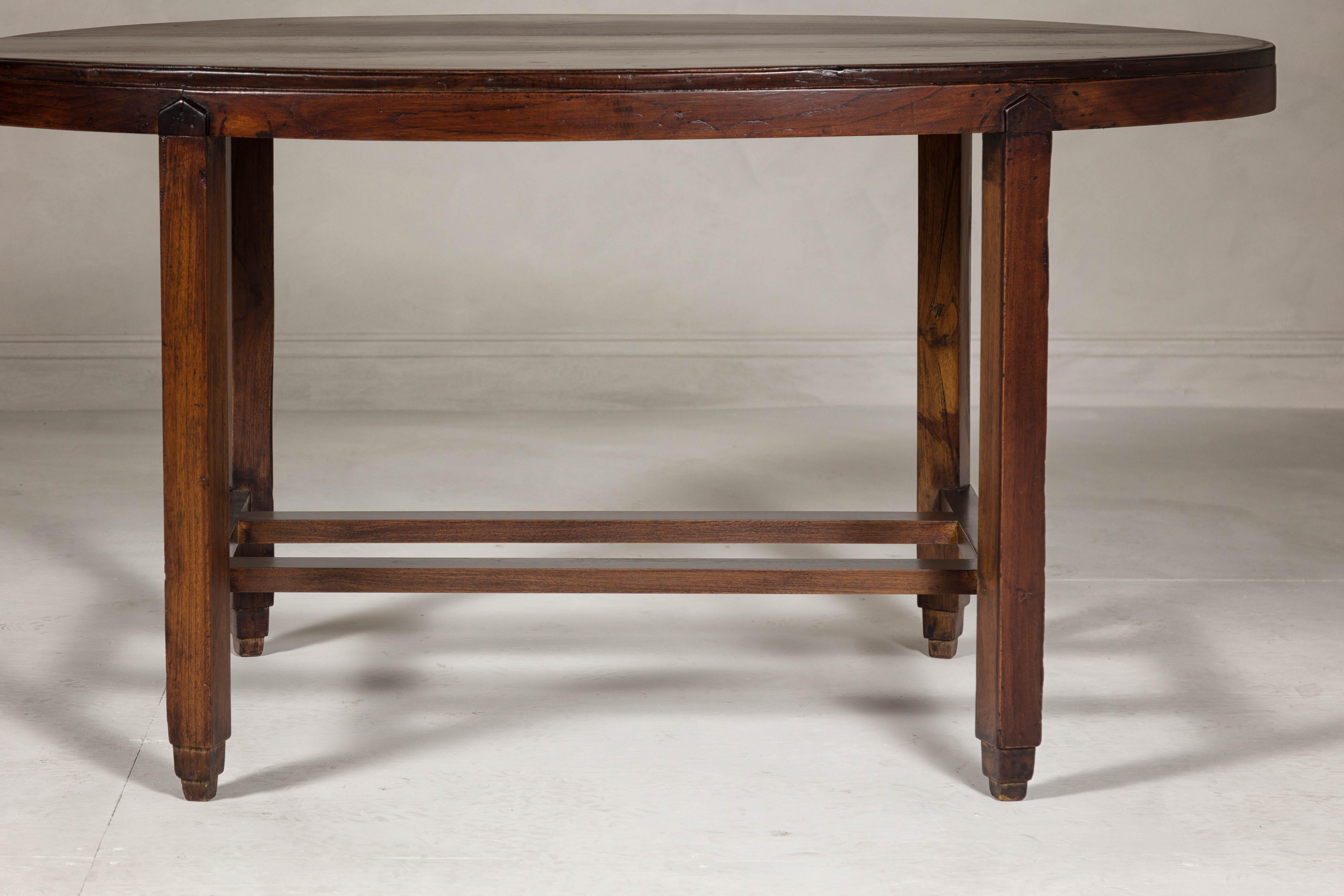 Wood Oval Top Center Table with Inverted Stepped Pyramid Feet and Cross Stretcher For Sale