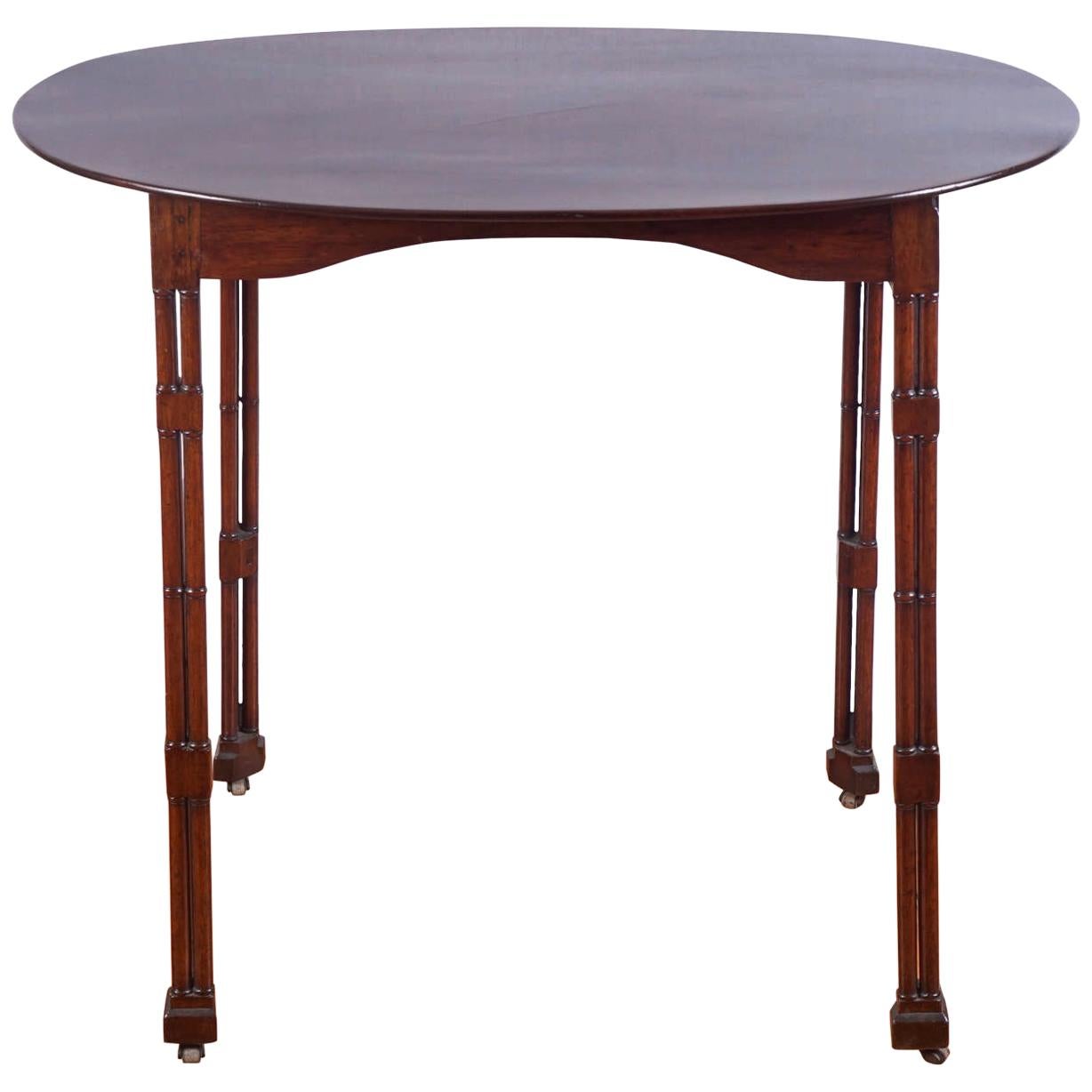 Oval Topped Regency Mahogany Side Table on Casters For Sale