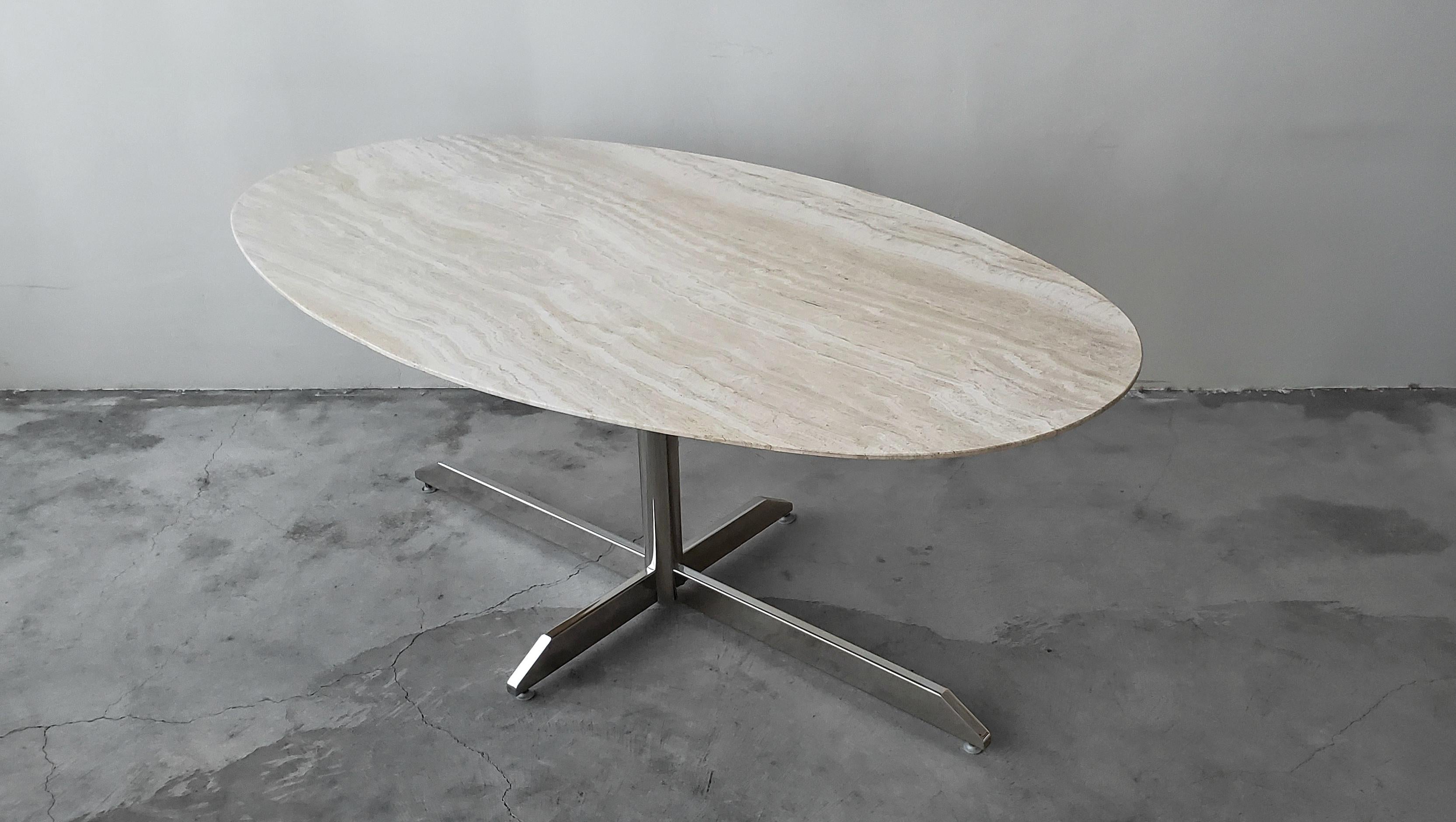 Absolutely beautiful oval travertine and chrome dining table by Florence Knoll for Roche Bobois. Nothing short of amazing. This table screams designer simplicity. Such a versatile table that could be paired with almost any chairs in any decor