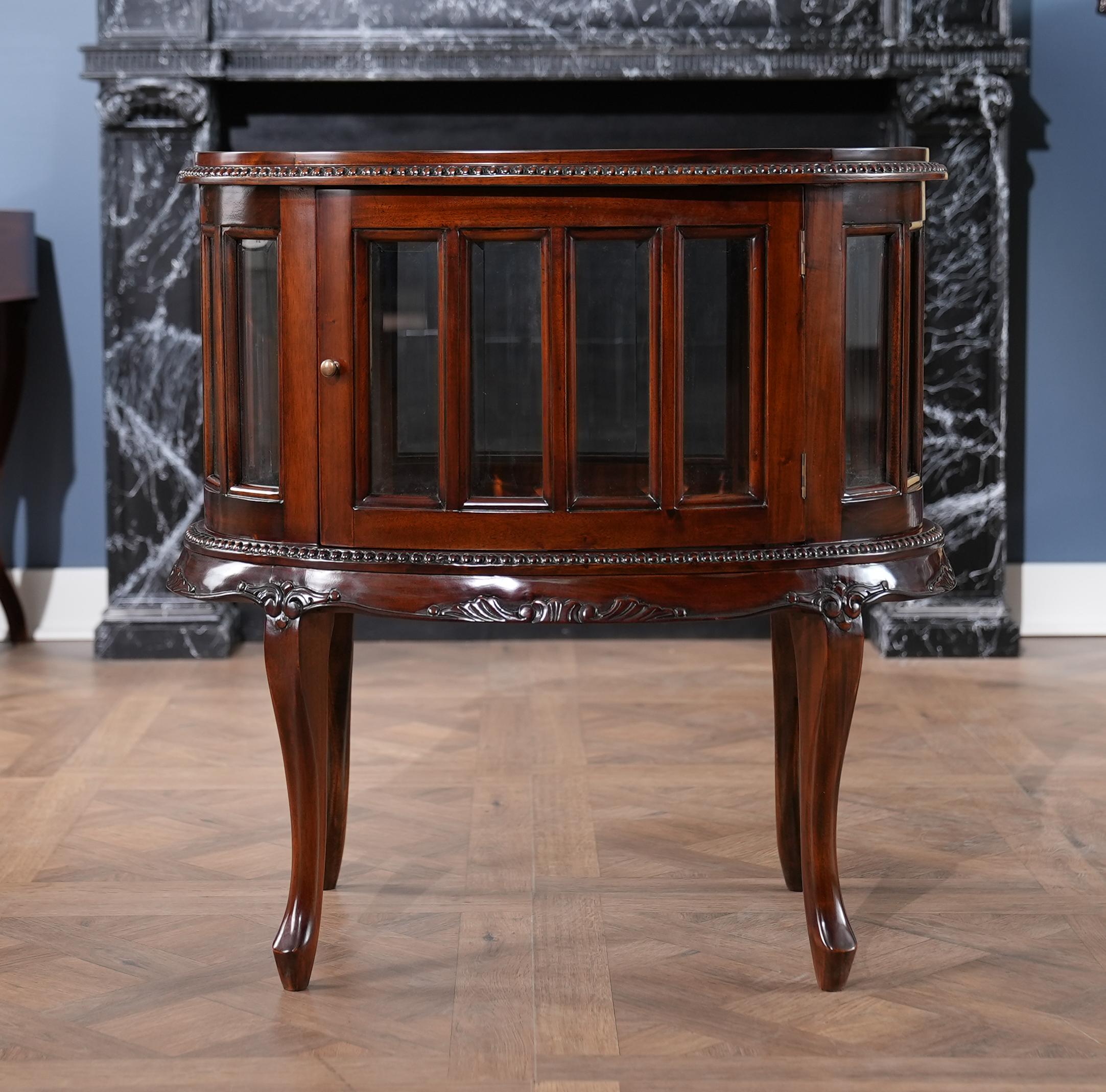 The Oval Tray Top Mahogany Display Table from Niagara Furniture is an exercise in elegance. The sweeping mahogany legs are created by hand and support the table’s finely carved skirt and glassed in display area which itself features individual