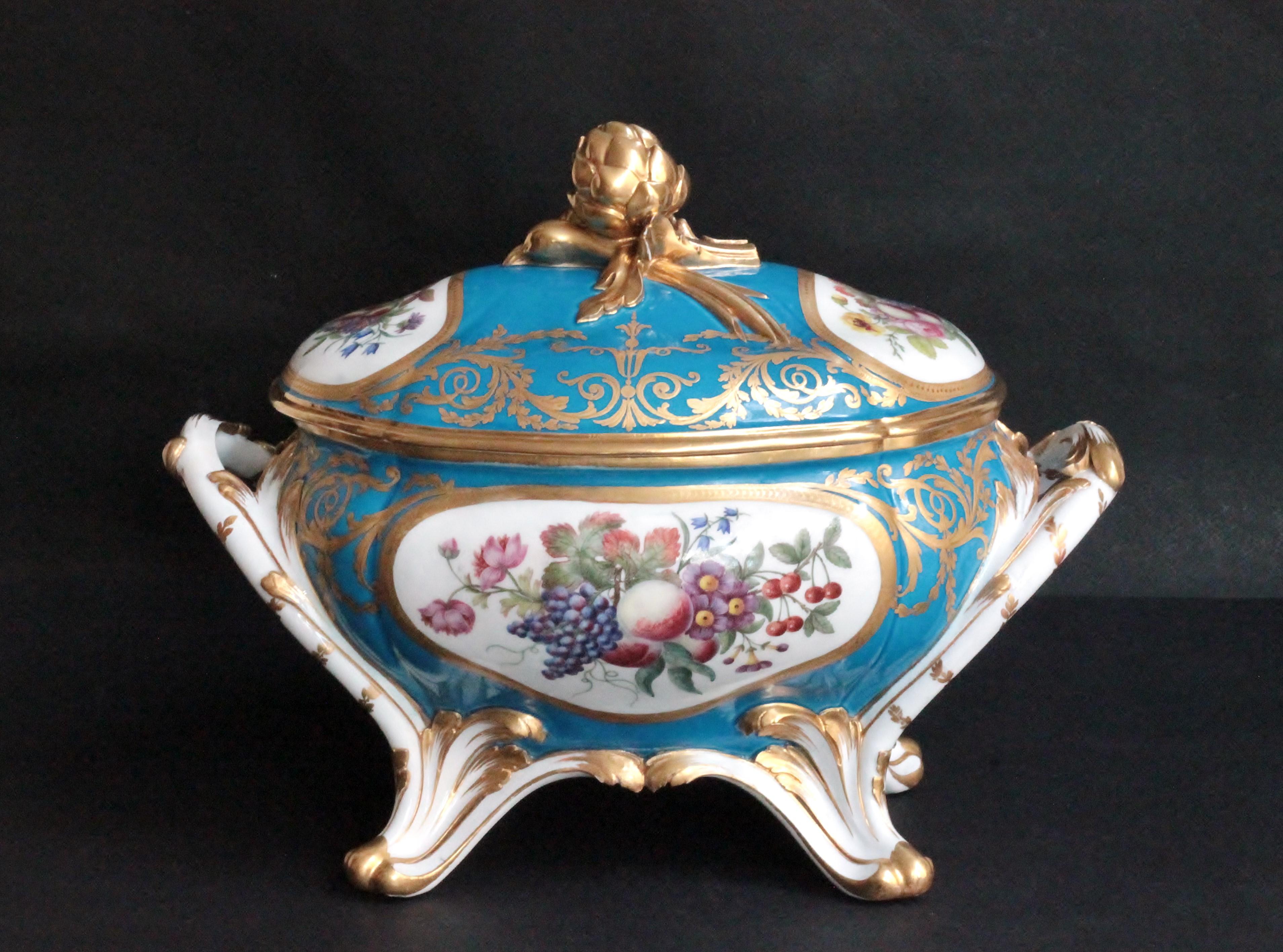 Oval tureen and cover of soft-paste Sevres porcelain, turquoise blue ground (bleu celeste) with gilded decoration. Bunches of flowers and fruit are painted in the four oval reserves on the tureen and cover. Linking the reserves are gilded arabesques