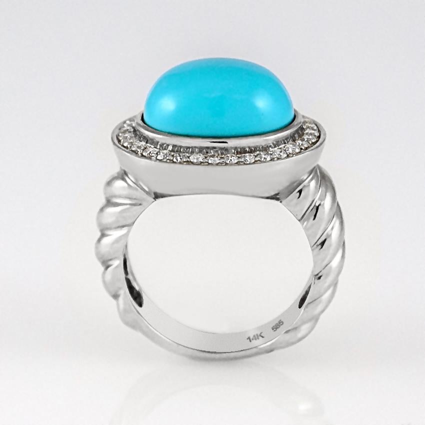 Beautiful oval shape cabochon turquoise ring surrounded by .37 carats of diamonds set in 14 karat white gold in twisted ropes style. This women's cocktail statement ring is available in stock. It is in size 7 and if needed it can be resized.