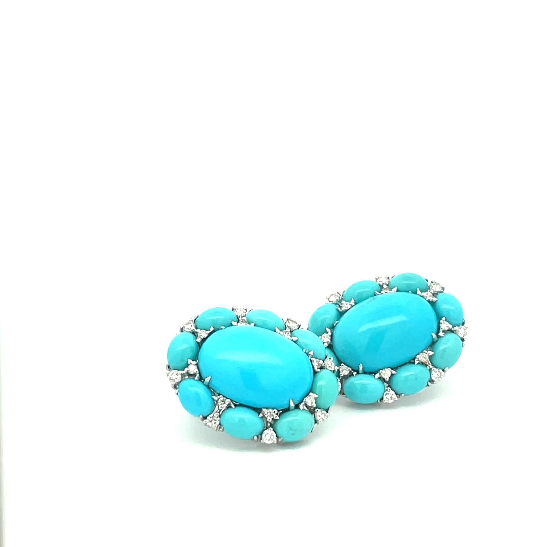 A pair of 18kt white gold oval turquoise earrings set with natural white diamonds with straight post and omega clip system.

32 brilliant cut diamonds 0.79ct total weight

18 oval turquoises 27.70ct total weight

18kt white gold weighing 13