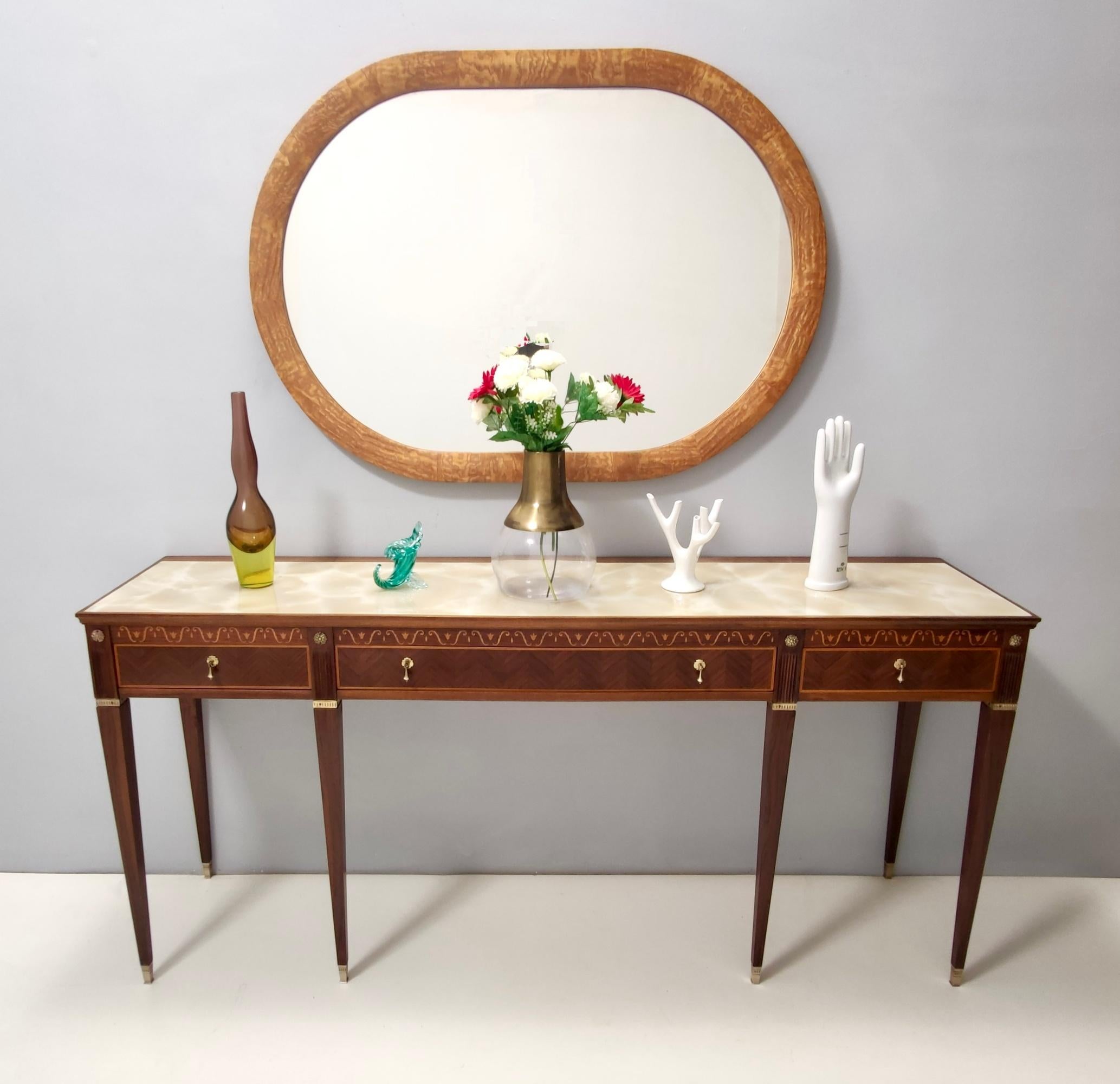 Made in Italy, 1950s.
This mirror features an oval ash root frame.
It might show slight traces of use since it's vintage, but it can be considered as in very good original condition and ready to become a piece in a home. 

Measures:
Width 131