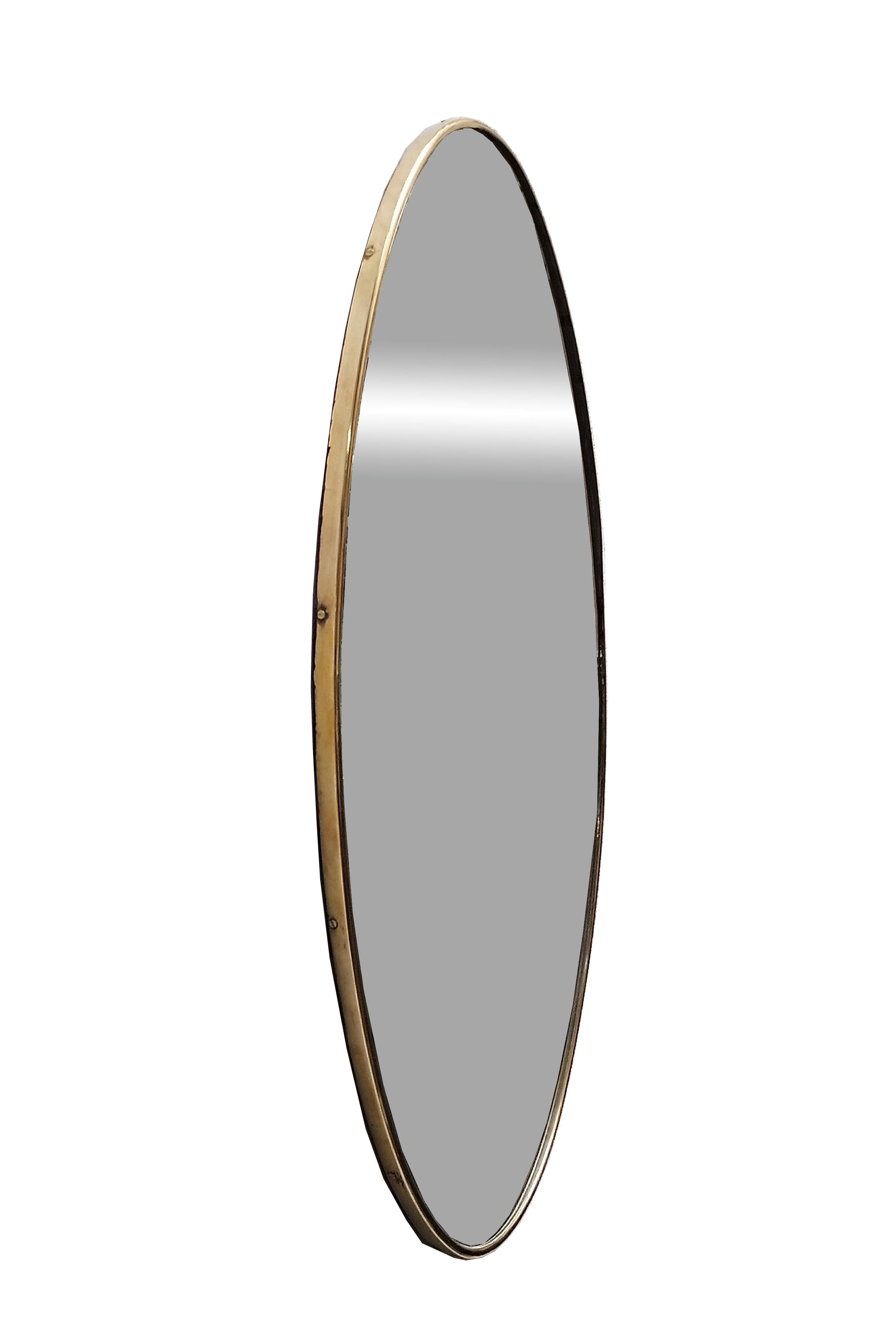 Mid-century Italian wall mirror with brass frame.  The oval shape is rare in this style of mirror. It is in fair vintage condition, with a characteristic aged patina on the brass frame. 
