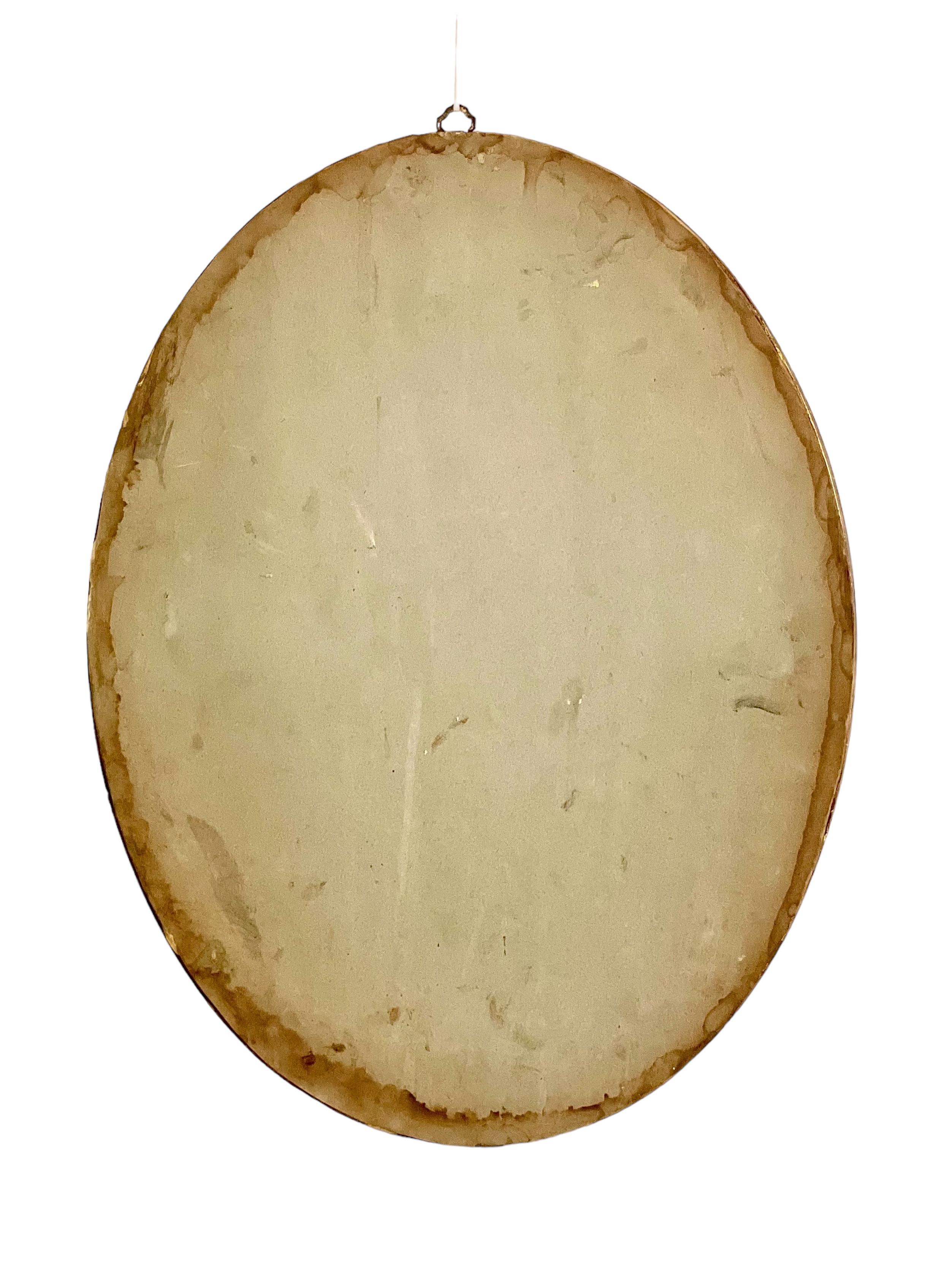 Doré Miroir mural ovale en bois doré en vente