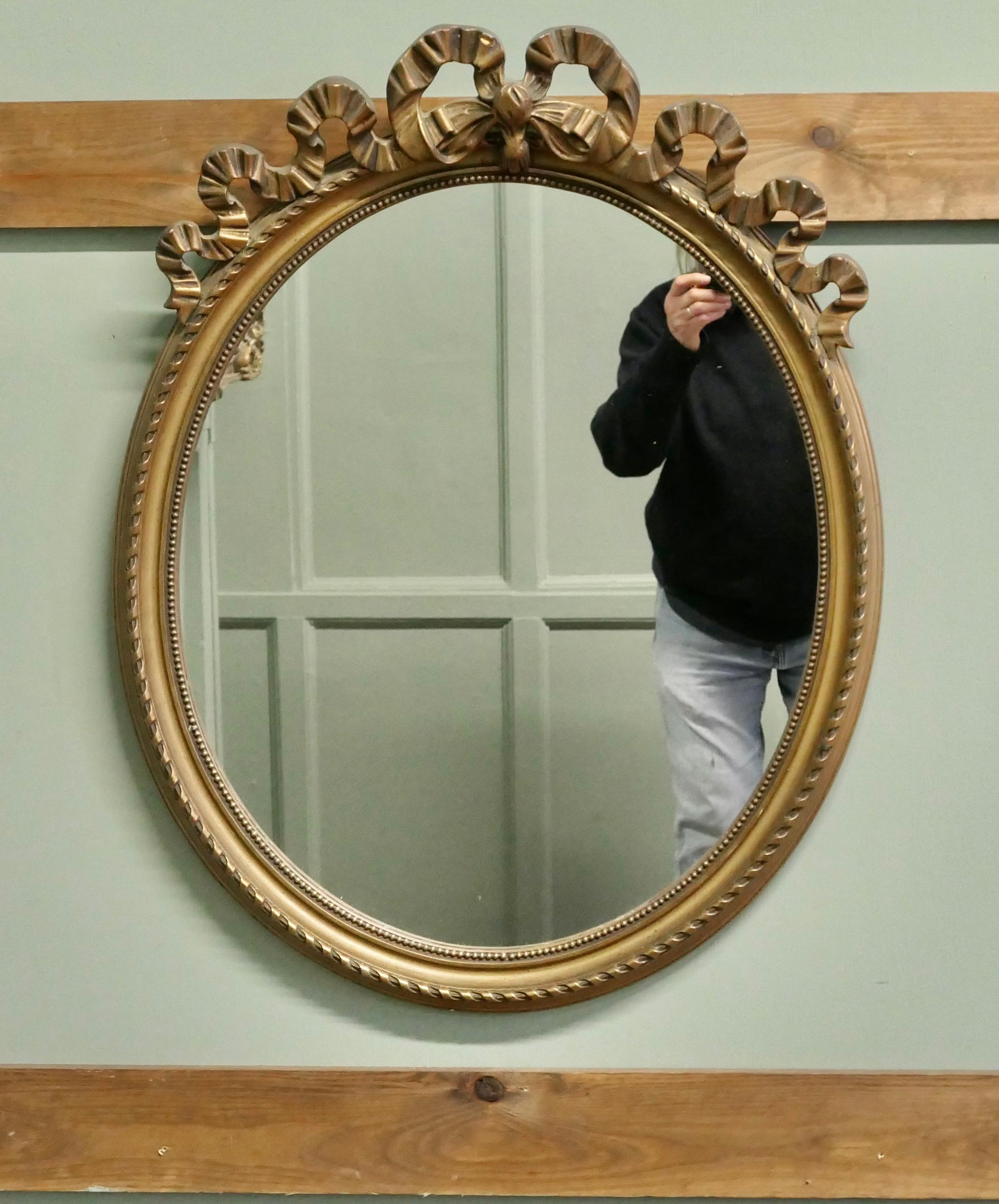 Specchio ovale da parete dorato e decorato con nastri

La cornice in oro scuro ha una bellissima decorazione a fiocco e nastro sulla parte superiore.
Il vetro e la cornice dello specchio sono in buone condizioni, la cornice è molto bella. 
Lo